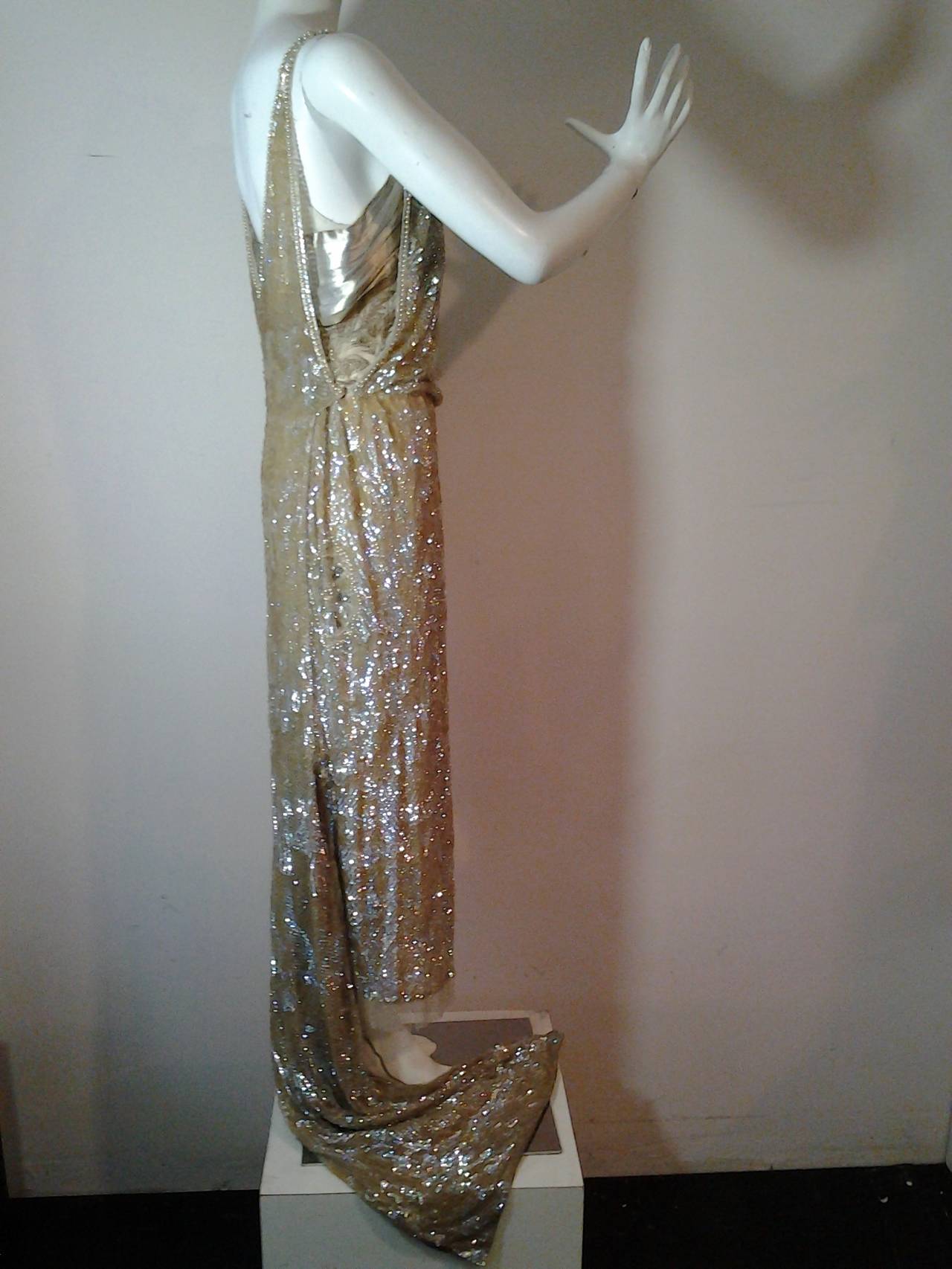 An absolute museum-worthy early 1920s French-made sequined and beaded dropped-waist tabard-style evening or wedding gown:  outer overlay is completely covered in iridescent sequins and beading.  Under layer is gold metal and silk lame.  Under dress