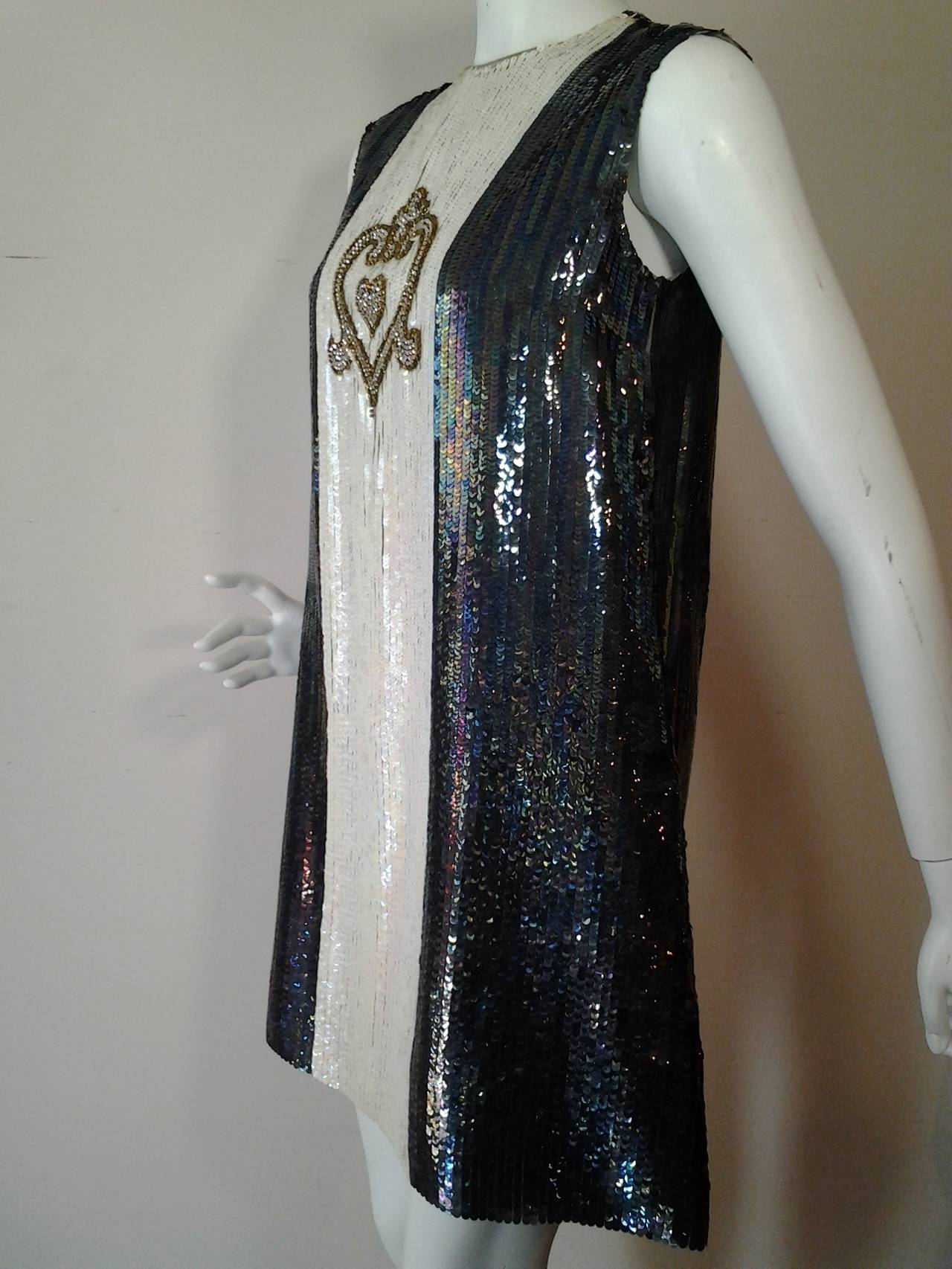 1960s Chester Weinberg Mod, A-line, black and white iridescent sequined, racing stripe mini dress with rhinestone heart emblem.  Completely lined in separate crepe layer that is closer fitting.  Snaps at back .