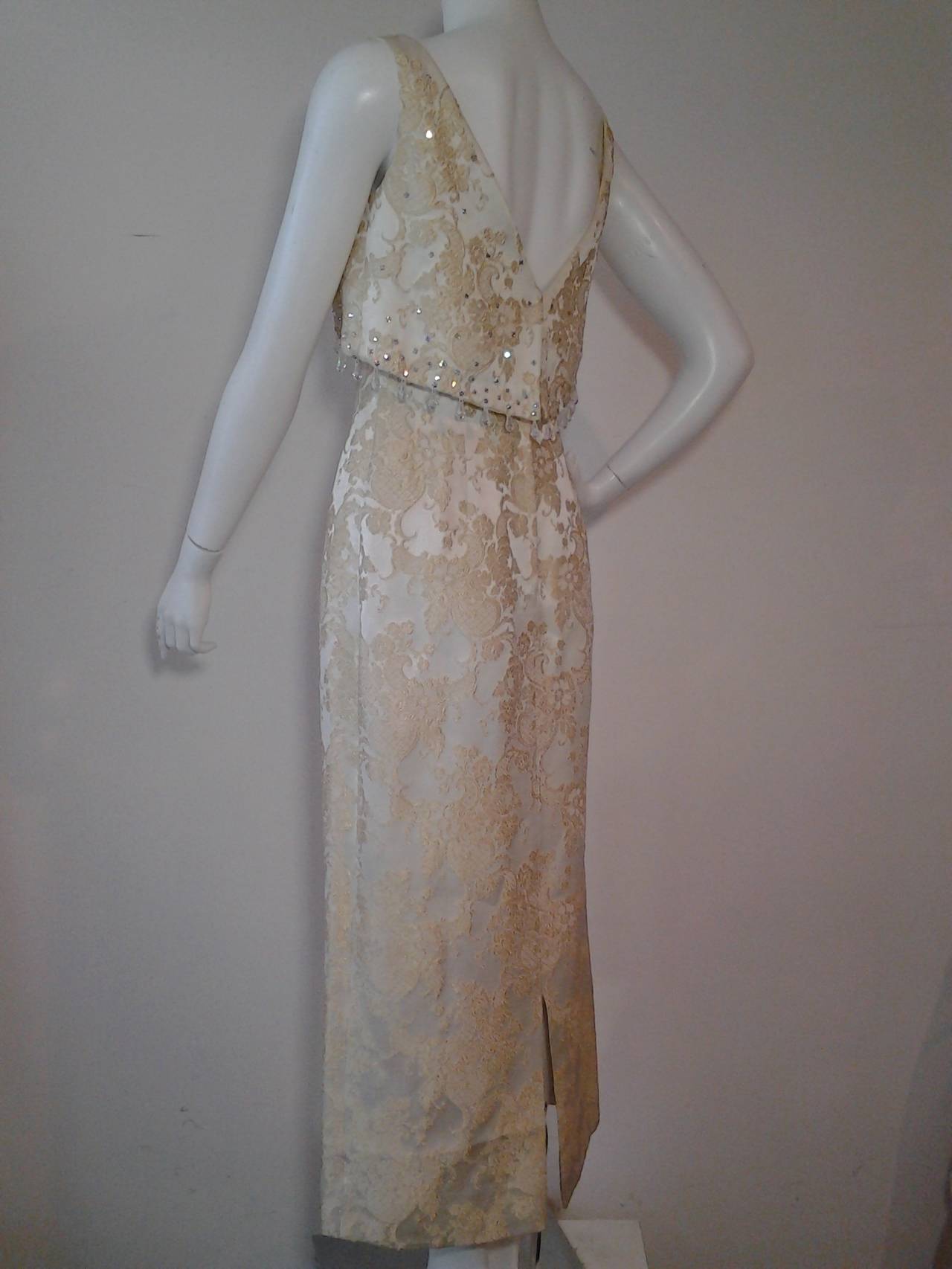 1960s Gold and cream brocade sheath gown w/ Empire jeweled and beaded floating bodice panel. Fully lined.  Zip back. Back slit