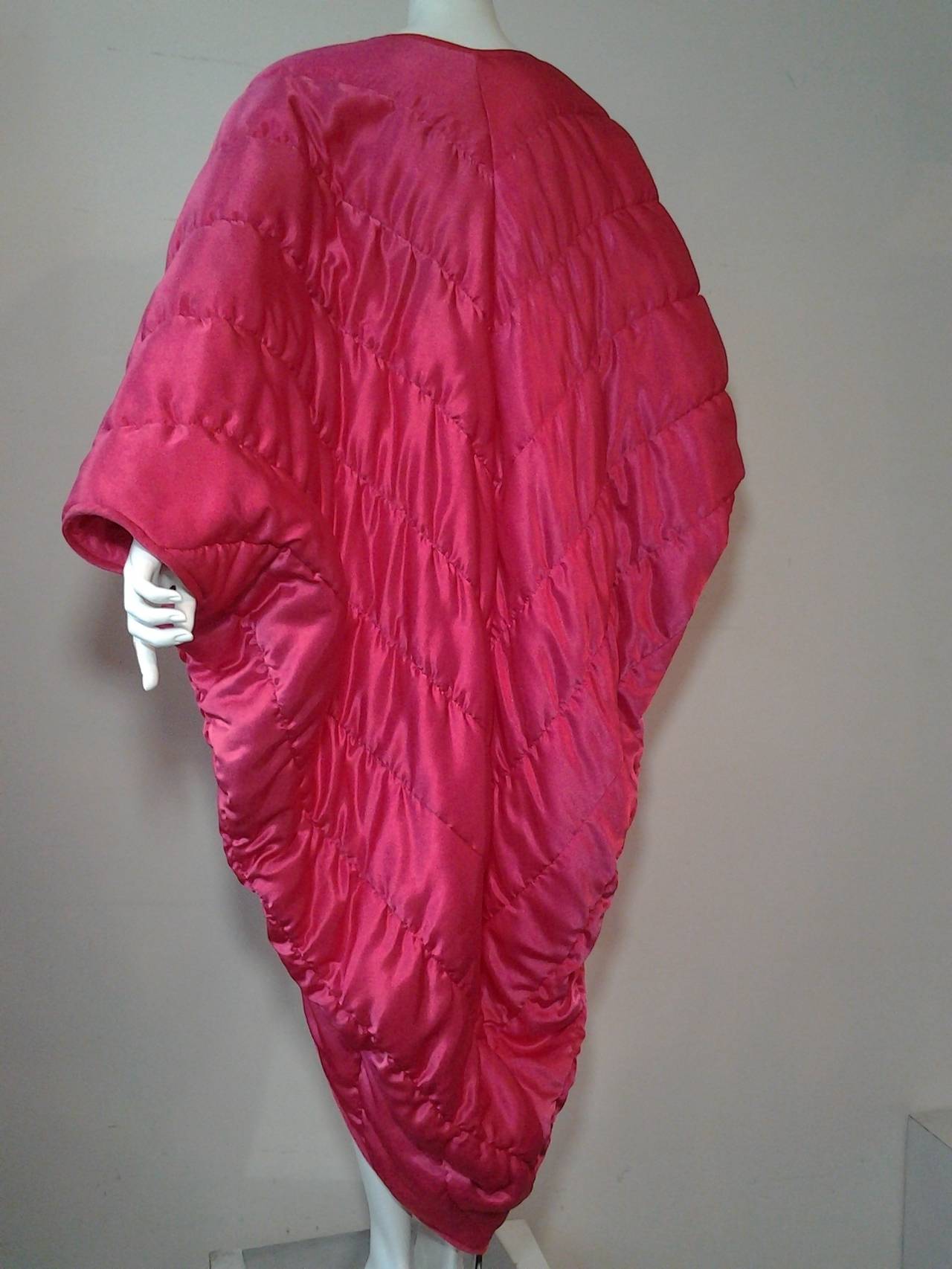 A fun 1980s vivid fuchsia satin quilted cocoon coat:  Unlined with no closures.