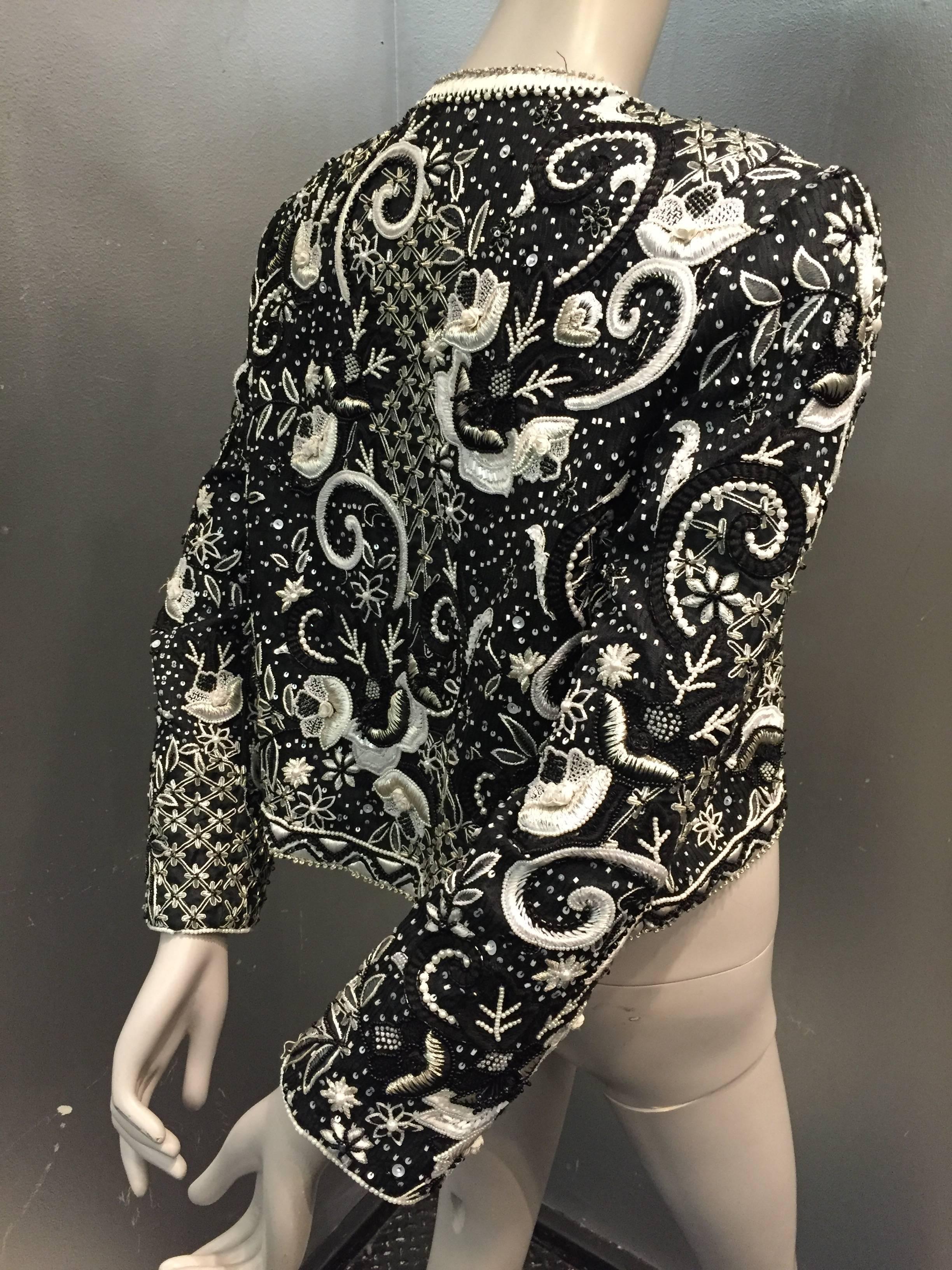 A gorgeous 1980s Givenchy Couture heavily beaded and embroidered evening jacket in black and white. Padded shoulders, no collar. Fully lined in silk. Hook and eye closure at neck. Made in France
