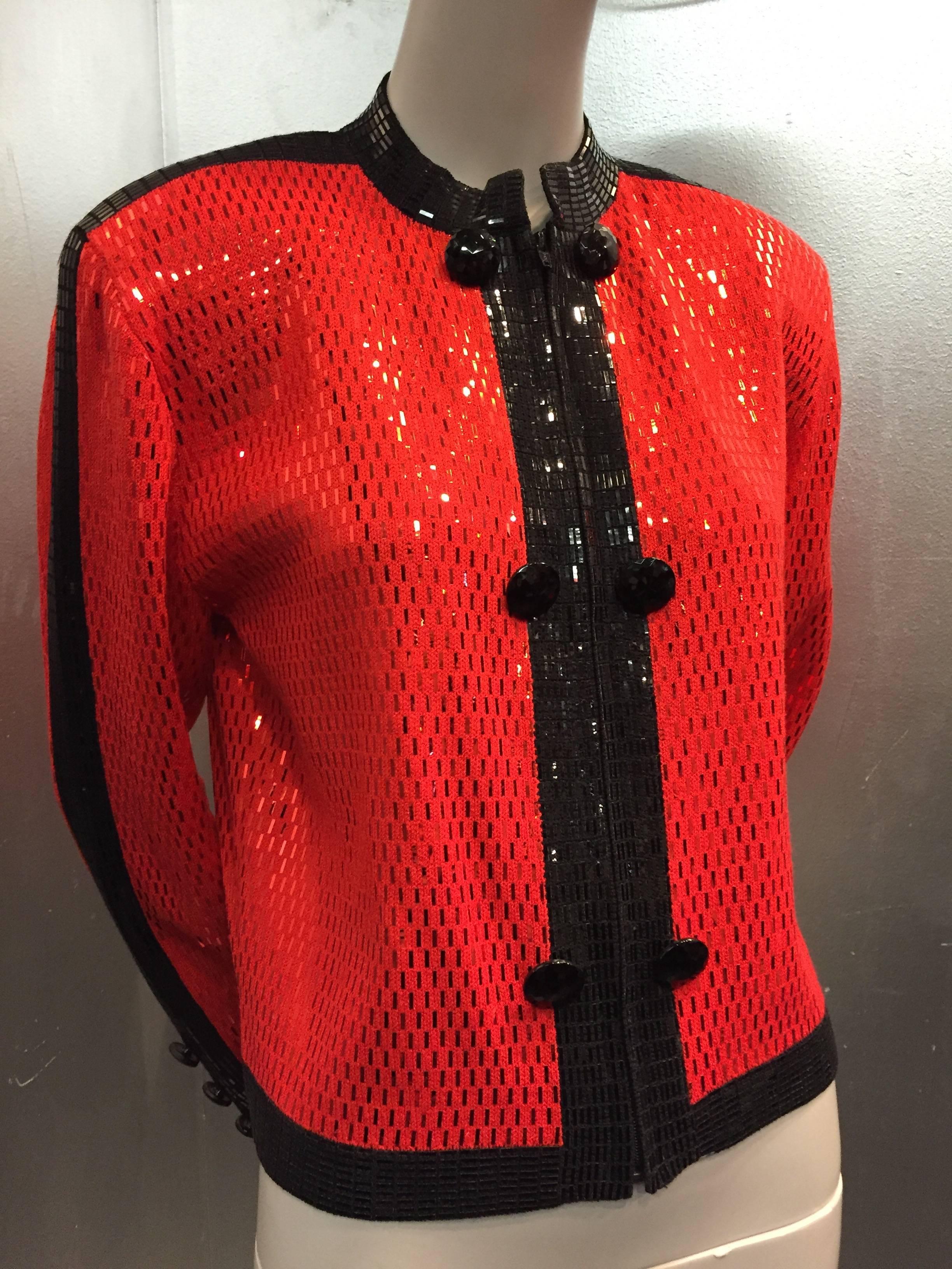 1980s St. John Evening jacket: Red and black rayon knit with zippered front.  Entirely covered in corresponding heat-set bar sequins.  Black plastic faceted buttons at front and sleeve cuffs. Unlined. 