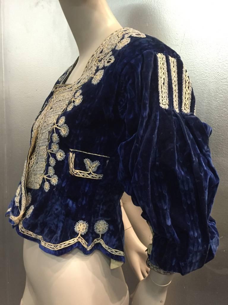 1930s Bolivian Hand-crafted saphire blue velvet jacket of llama wool with elaborate traditional folk style embroidery and seed beading.  Front hook closures as well as cuffs.  Peplum style with full sleeves. 