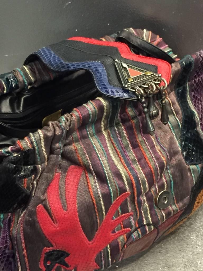 1980s Sharif multicolored and striped brocade handbag with snakeskin appliqués of birds and geometric shapes in various colors. Metal beaded clasp. Zippered pocket inside and optional black leather shoulder strap. 