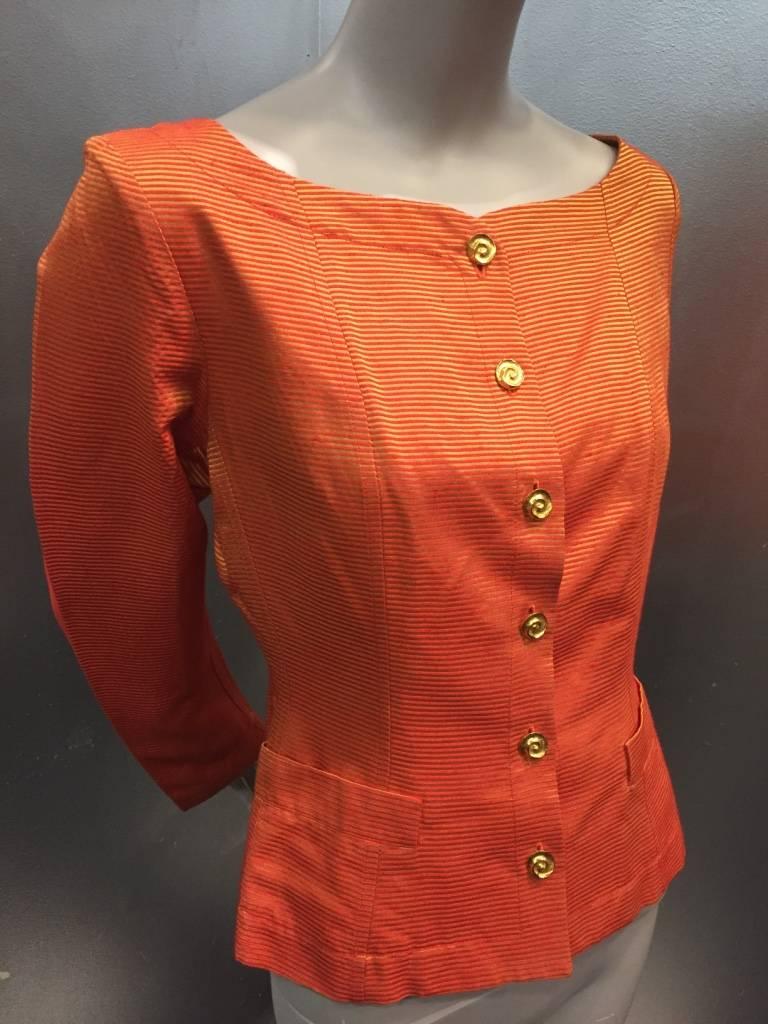 1980s Yves Saint Laurent gold and orange rayon and acetate faille jacket: unlined with wide cut, collarless neckline, small placket pockets at waist and gold swirl buttons down front and at cuffs. 