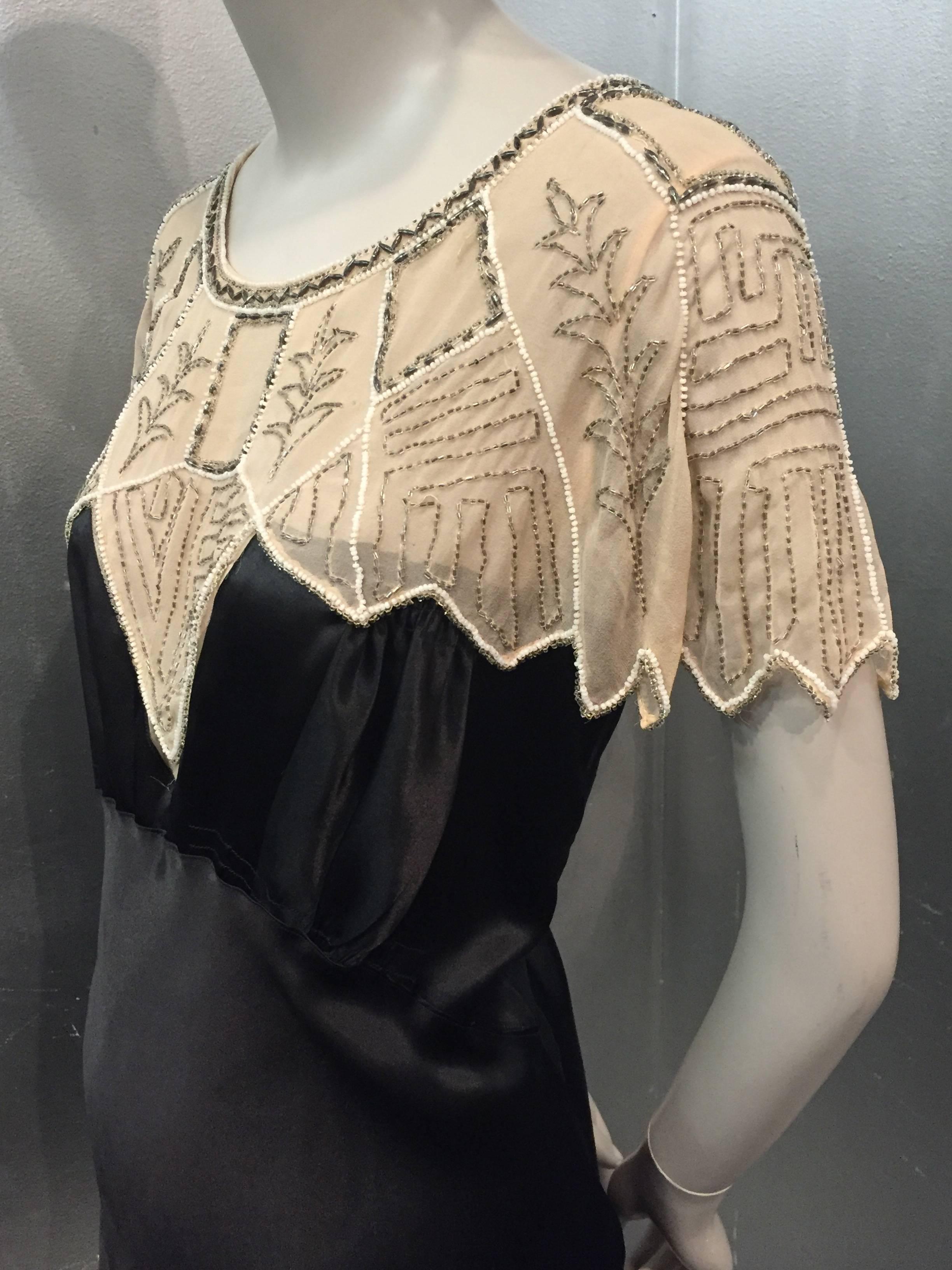 1920s Art Deco black silk satin Gatsby-style cocktail dress with beaded ecru chiffon caplet. 