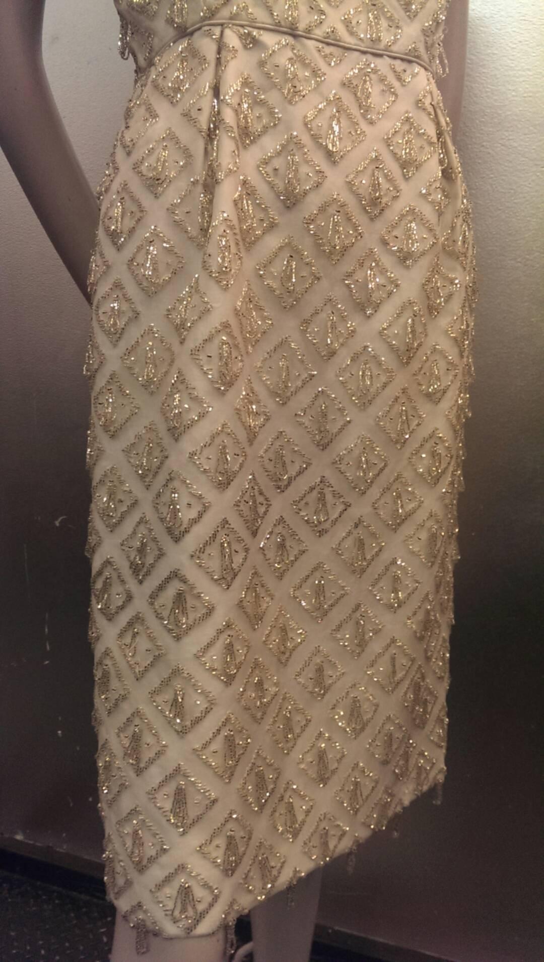 A gorgeous 1960s I. Magnin white silk organza fitted wiggle dress with champagne color bugle beads in a diamond pattern with beaded loops. Fully lined in cotton. Back zipper. 26
