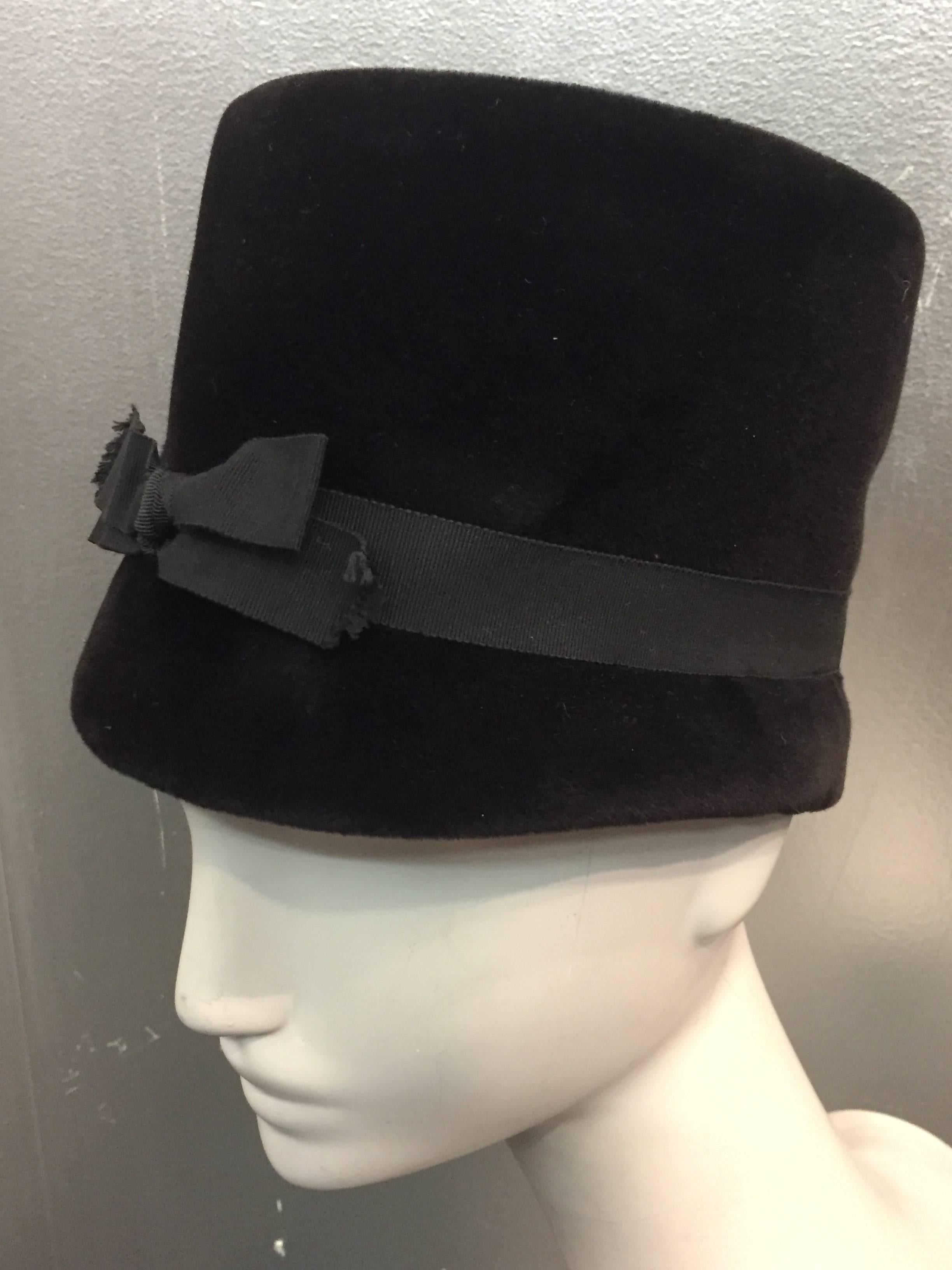 Beautiful and pristine chocolate brown velvet hat, in a mod 1960's fanfare. Inside measures 21 inches in circumference.  Crown measures 6 inches tall. Made in France.