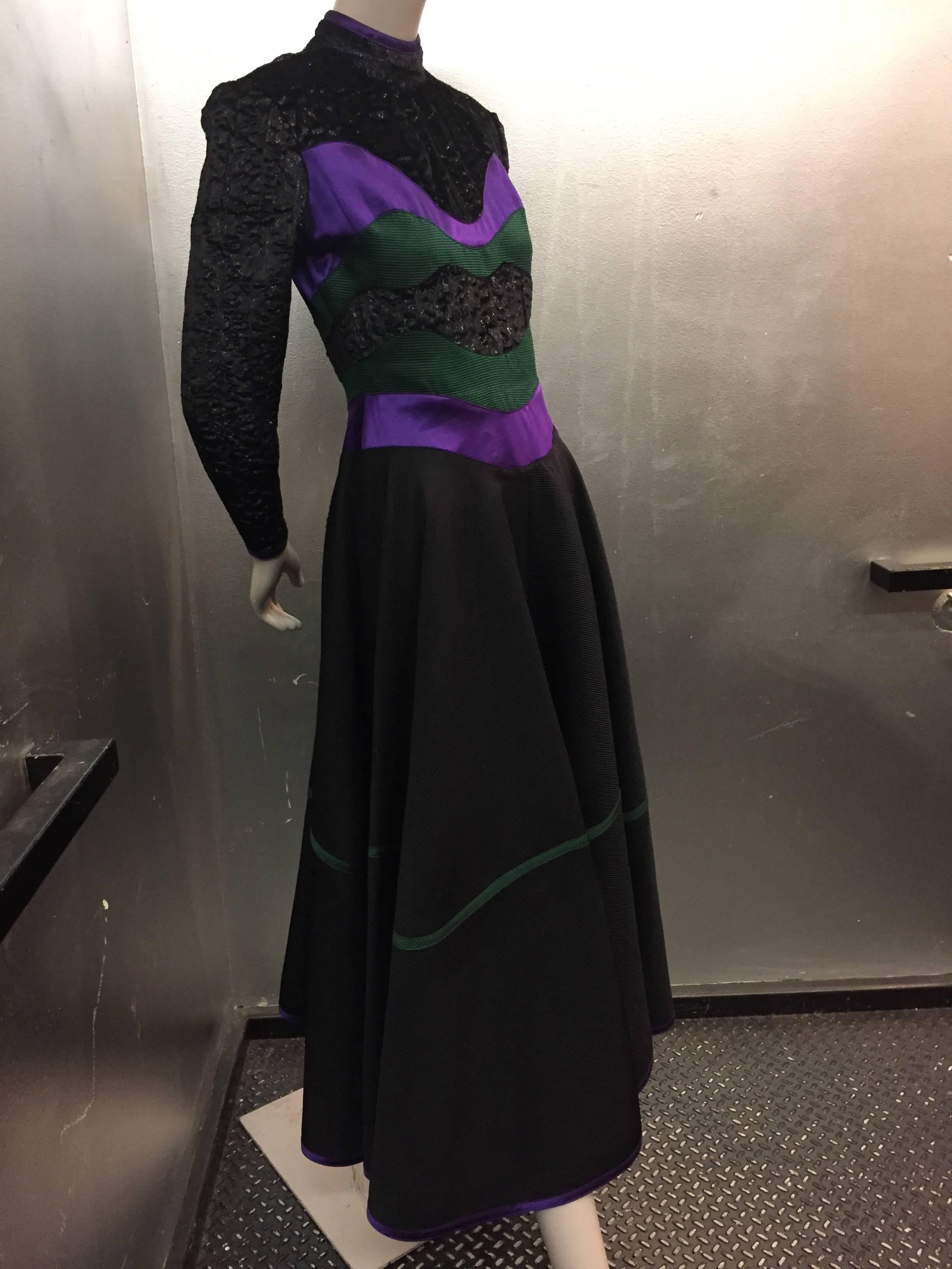 Geoffrey Beene cocktail dress with dramatic color blocking in purple and green silk satin at waist and bodice.

Velvet black metallic thread top portion of the dress and heavy silk faille bias skirt with full swing trimmed with matching accent