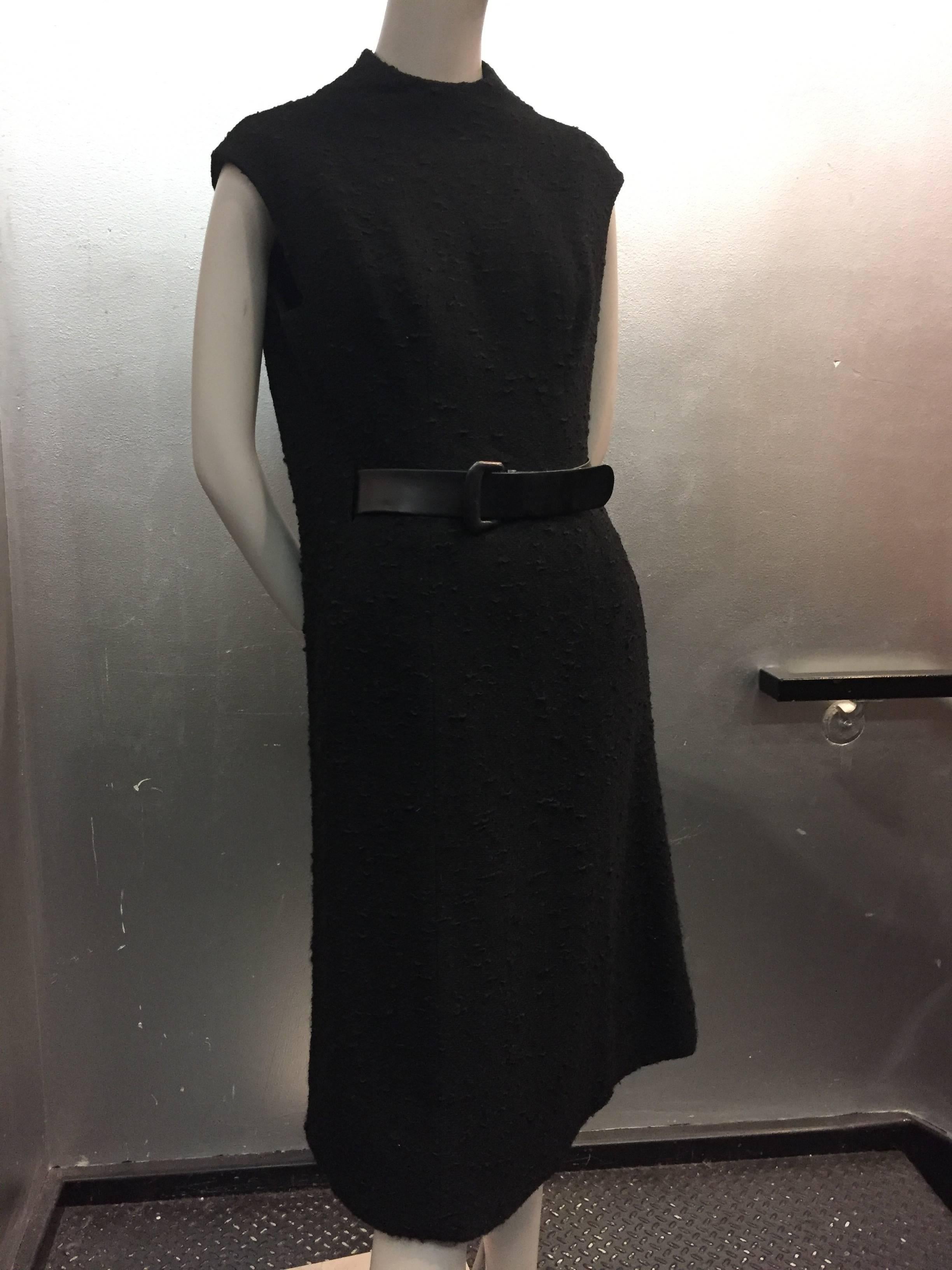 A spectacular tailored boucle shift dress with a high neck and beautifully designed leather belt technique at the waist.

The tailored boucle suit jacket features hand-crafted leather buttons and low open collar to showcase the dress.

Fully