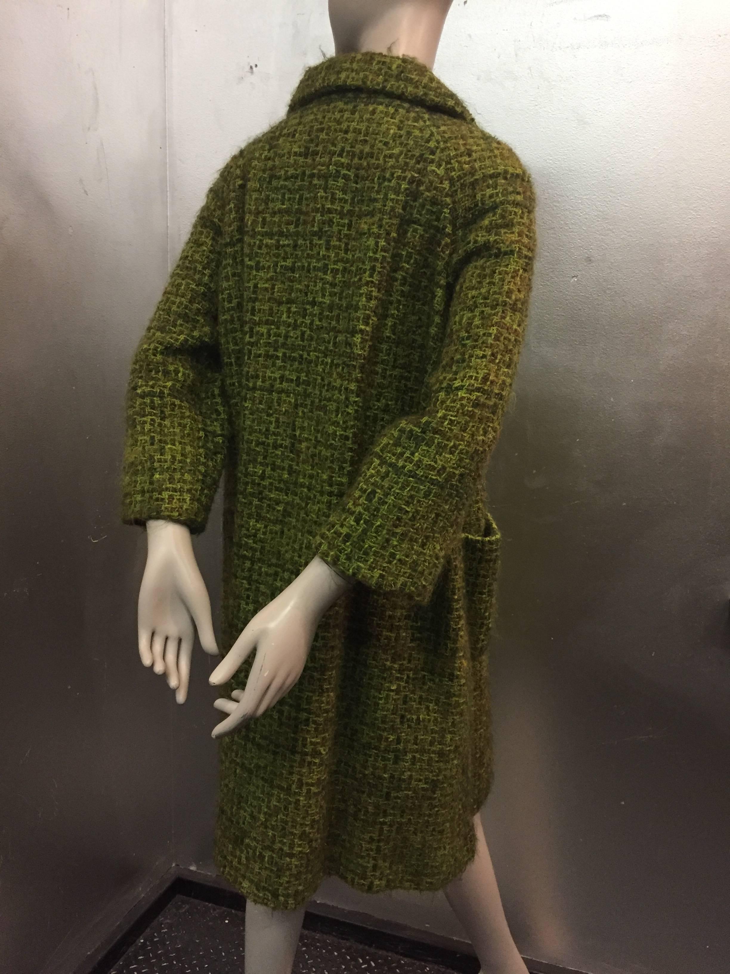 This coat features a full back, 3/4 length sleeve and stylized collar.

Outer pouch pockets and coordinating buttons.

Full green silk lining.

Perfect Mod style for Fall! 
