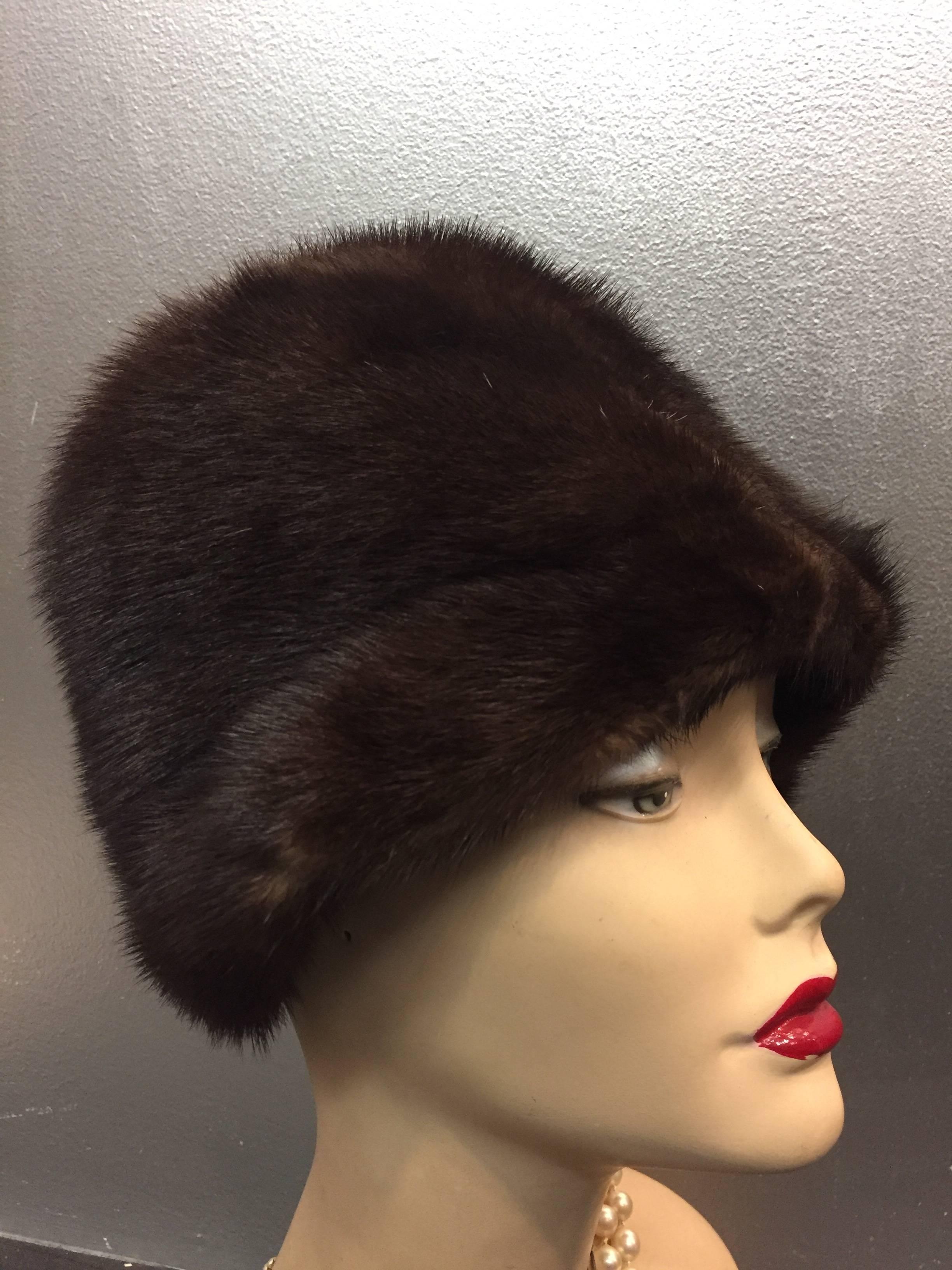 A warm and beautiful 1960s Saks Fifth Avenue natural mink cloche-style hat with rolled brim and pon pon. Completely lined. 