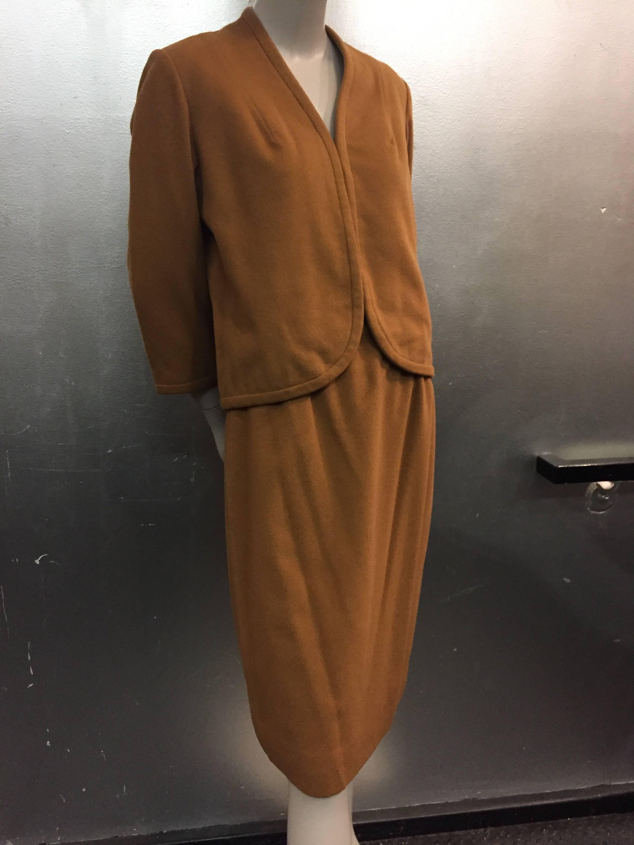 1960s Maison Mendessolle tobacco hued, luxurious vicuna textile, 3-piece skirt suit and coat ensemble.  All pieces are silk lined and beautifully tailored and constructed. Knee-length skirt.  Jacket has a beautiful curved hem with hidden hook and