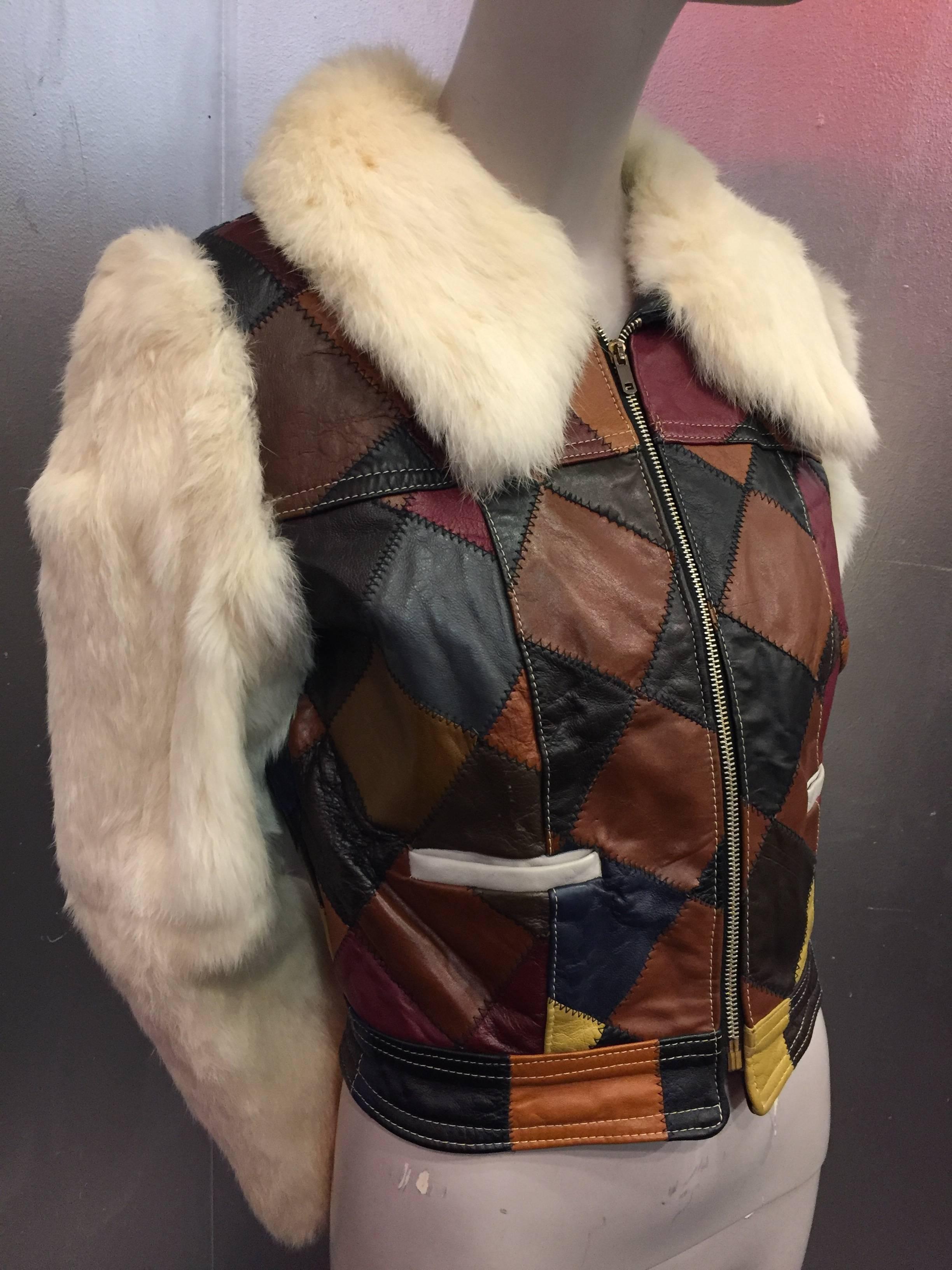 A fly and fabulous 1970s white rabbit fur and multicolor leather patchwork cropped jacket with front piped pockets, zipper closure and large lush collar. Quilted satin lining.
