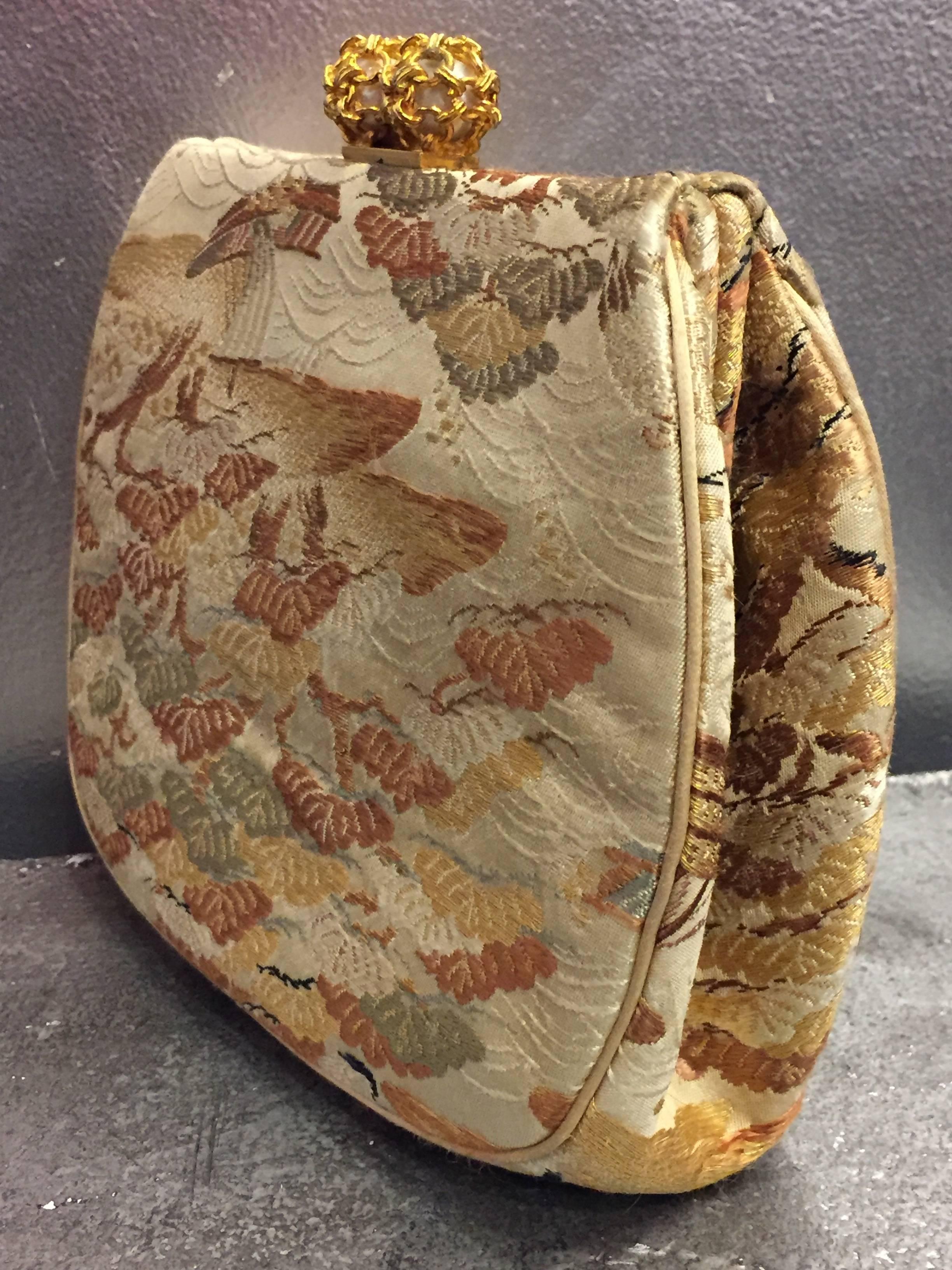 A beautiful 1950s Koret Asian silk fabric brocade clutch evening bag with faux gold and pearl clasp. Original change purse included. 