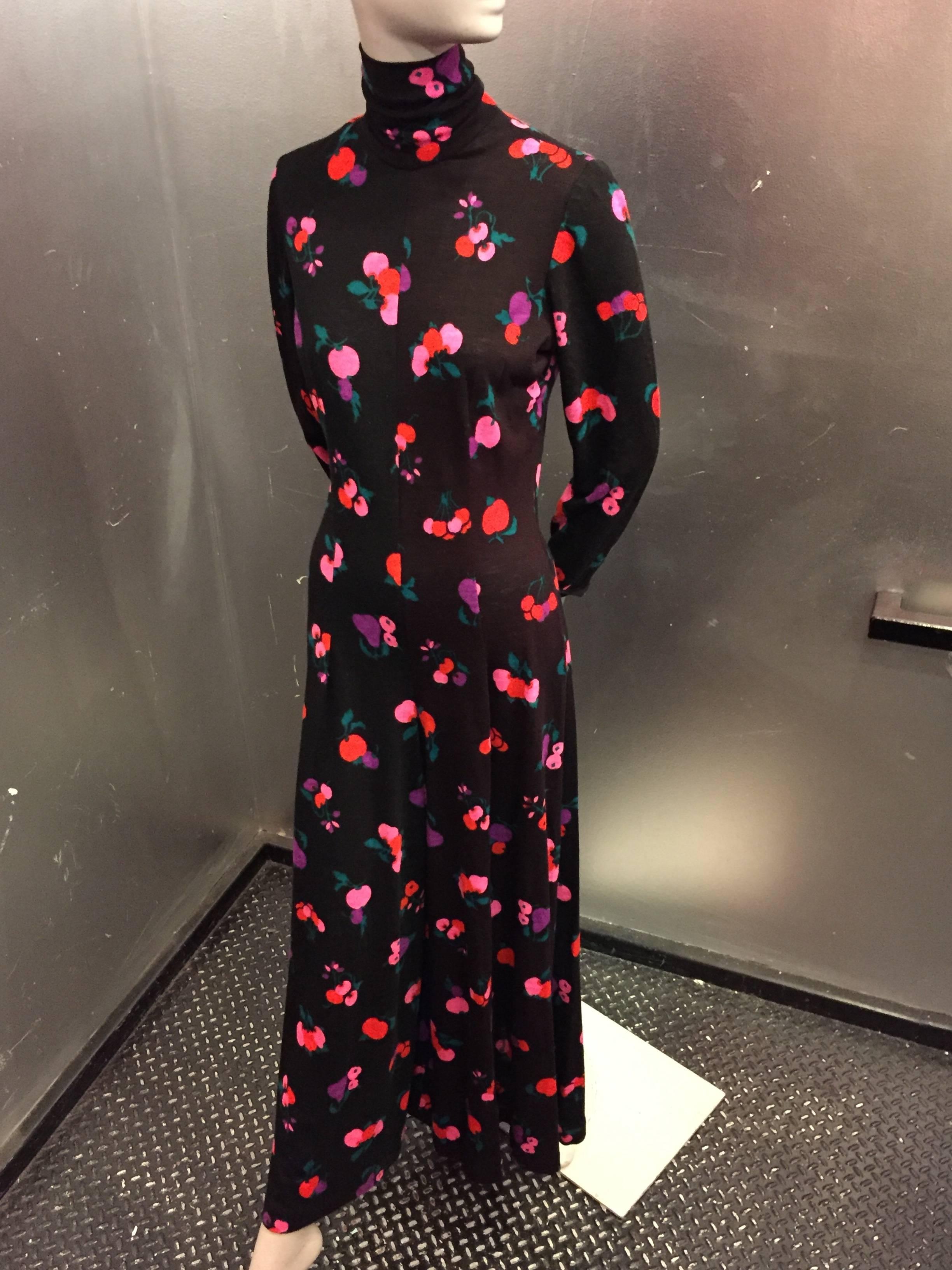 A fabulous 1970s Dorian by Lowell Judson acrylic jersey wide-legged jump suit with mock turtle neck and colorful cherry and blossom print on black ground.  Back zip. 