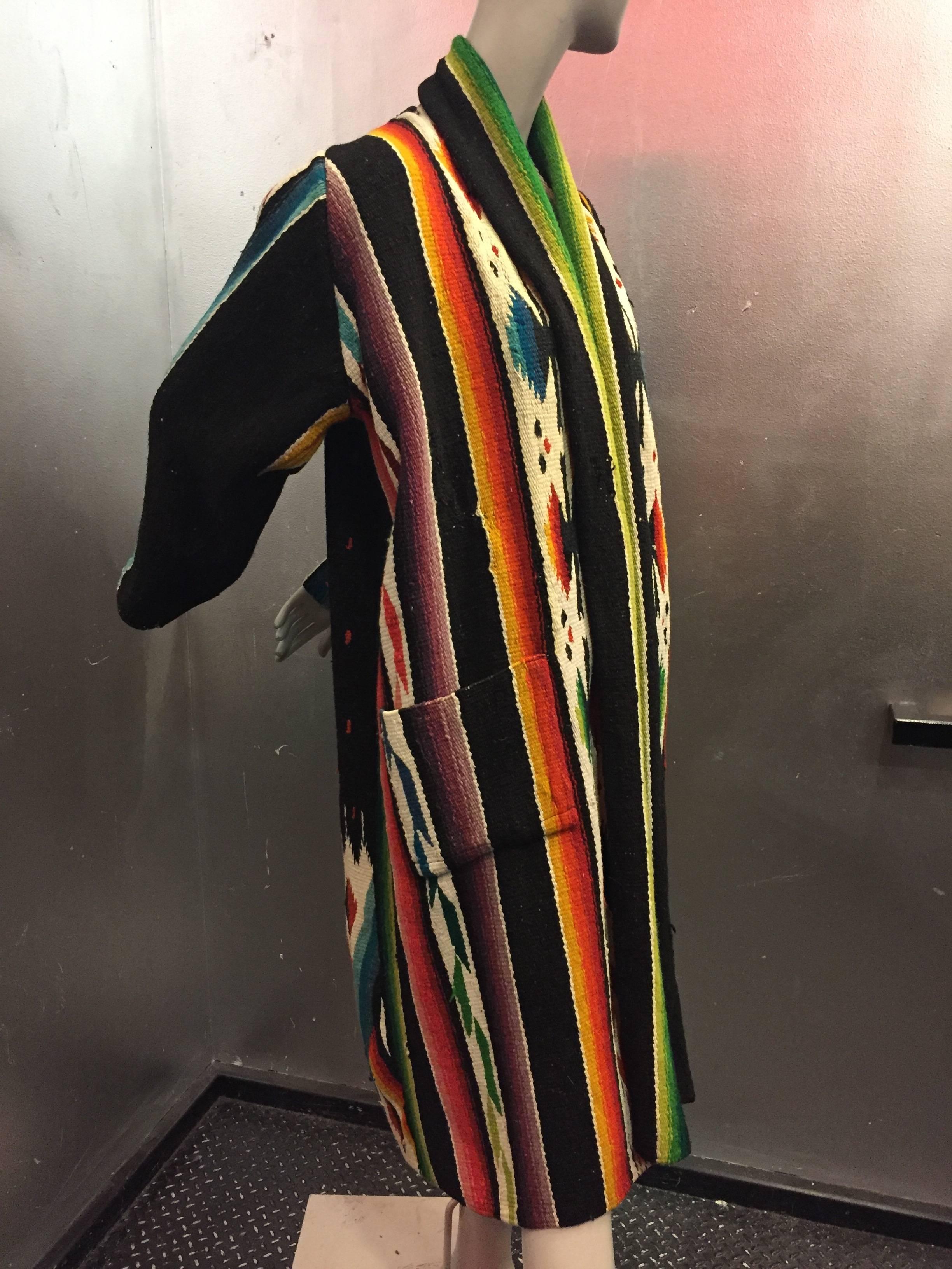A gorgeous 1940s vividly-colored, hand-woven, wool Chimayo robe-styled duster with patch pockets and shawl collar.