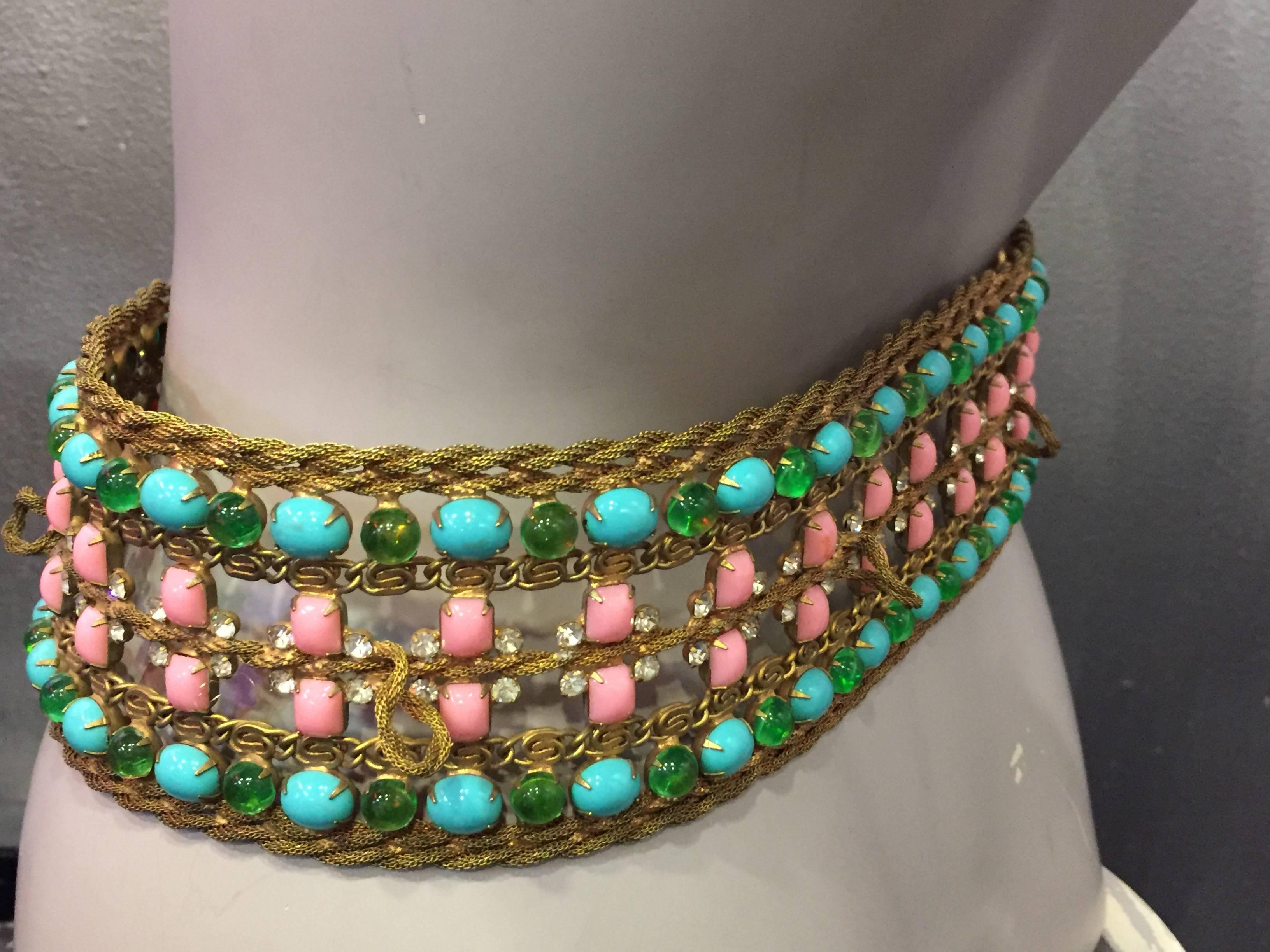 A fabulous and rare 1960s Kenneth Jay Lane gold-tone mesh and cabochon glass jewel belt. Jewels are all prong set and are in pink, emerald and turquoise.  One turquoise cabochon is missing. Belt measures 3