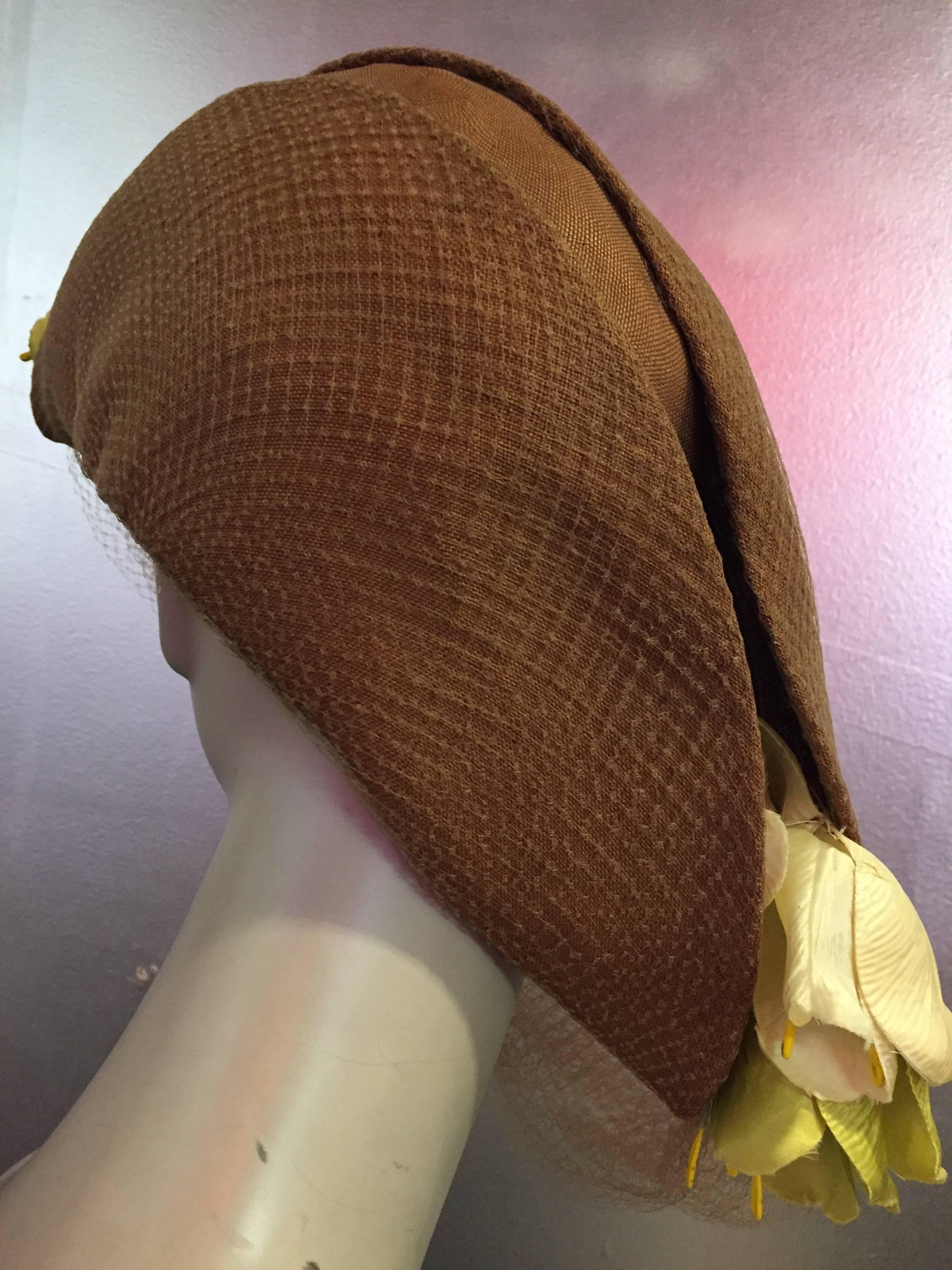 A superb and rare Avant Garde Irina Roublon fine tobacco hued straw bicorn hat with pale celadon and chartreuse silk tulips at points.  Tulle wimple drapes below jawline. 