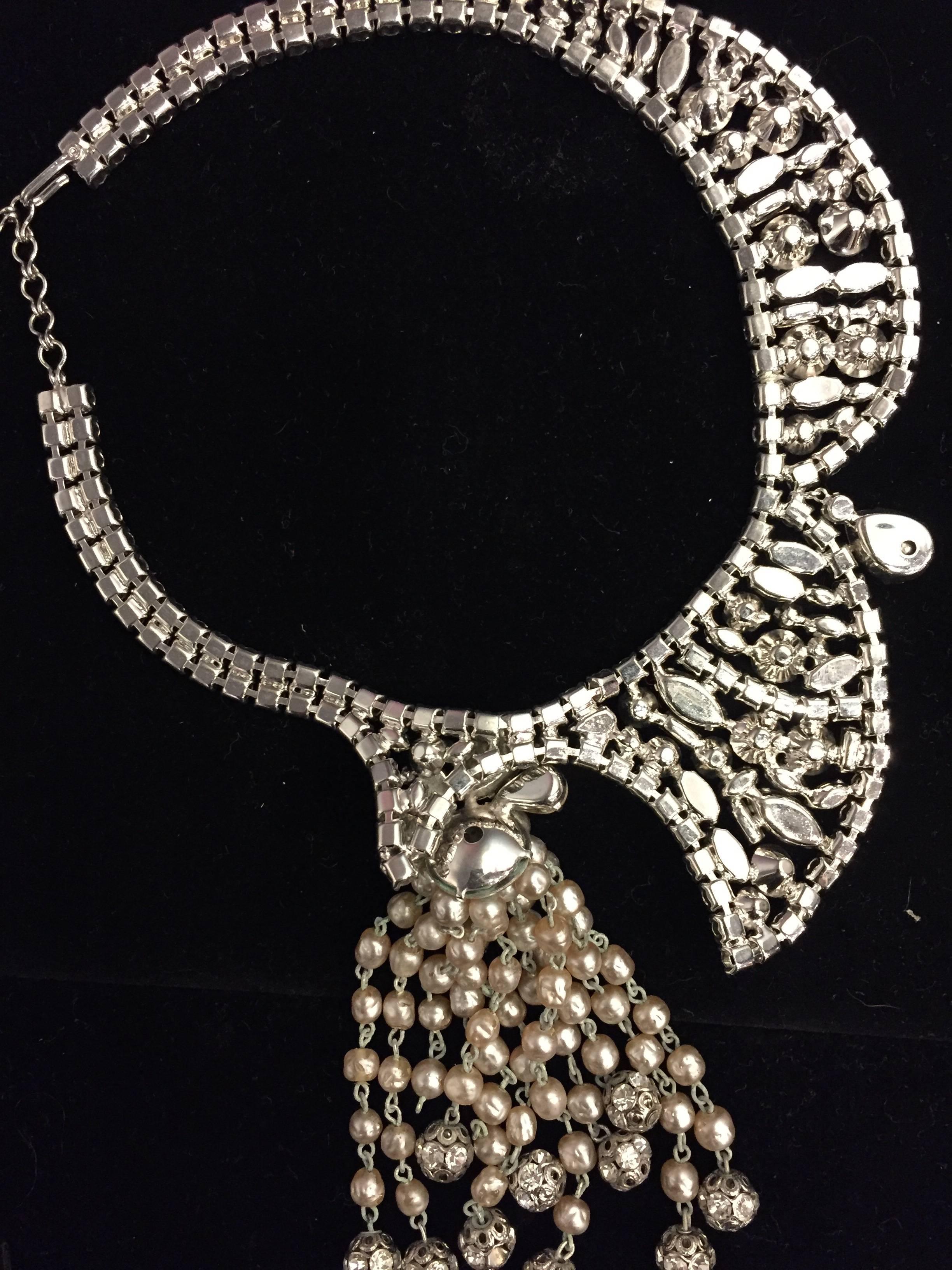A wonderful and unusually designed 1950s asymmetrical cascading tassel necklace and earring set in faux pearls and rhinestones. 