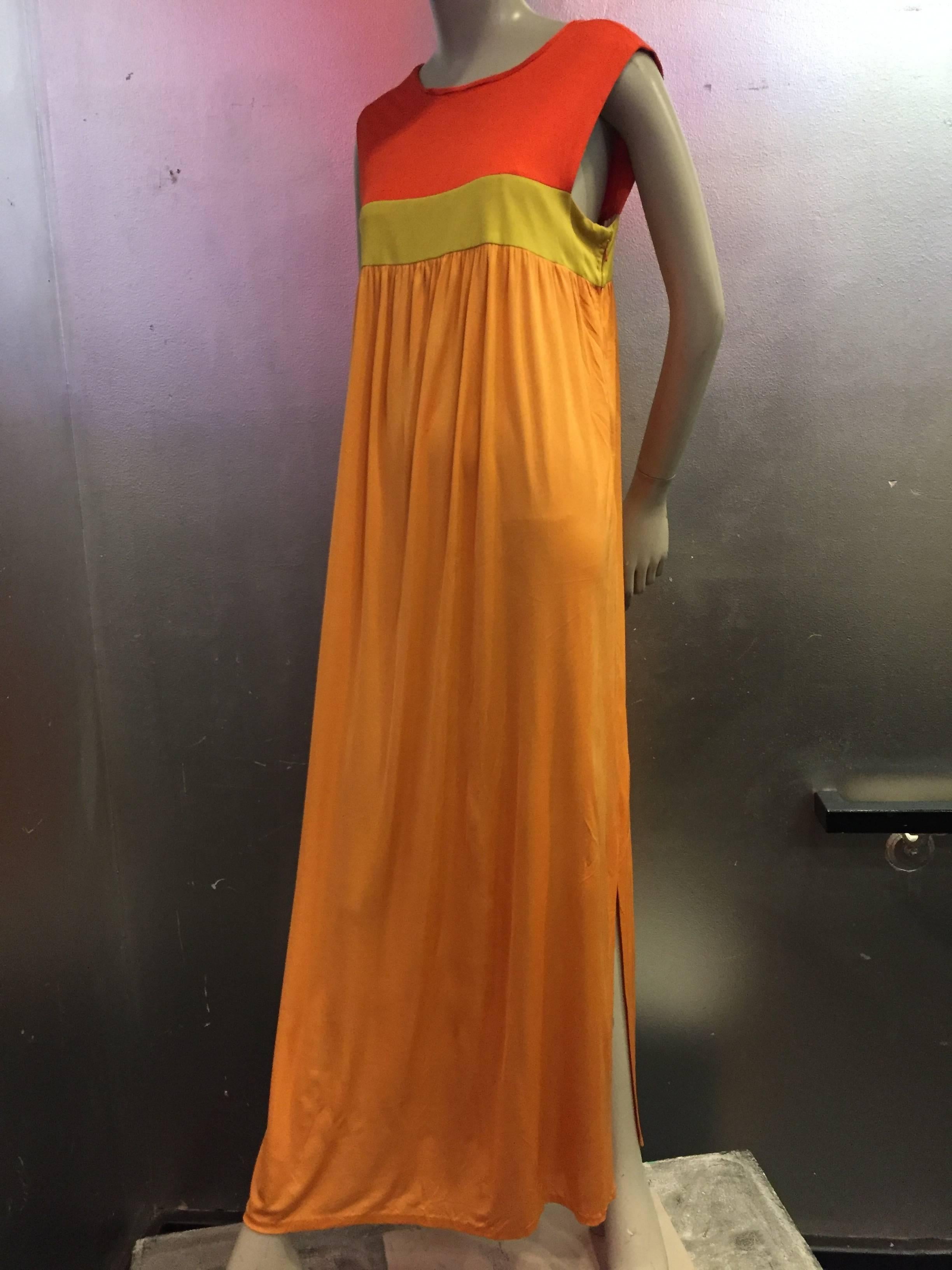 A fabulous and unusual 1960s Emilio Pucci color block Empire maxi gown in persimmon, chartreuse and tangerine color silk jersey.  Buttons at back of neck. Side slit. 