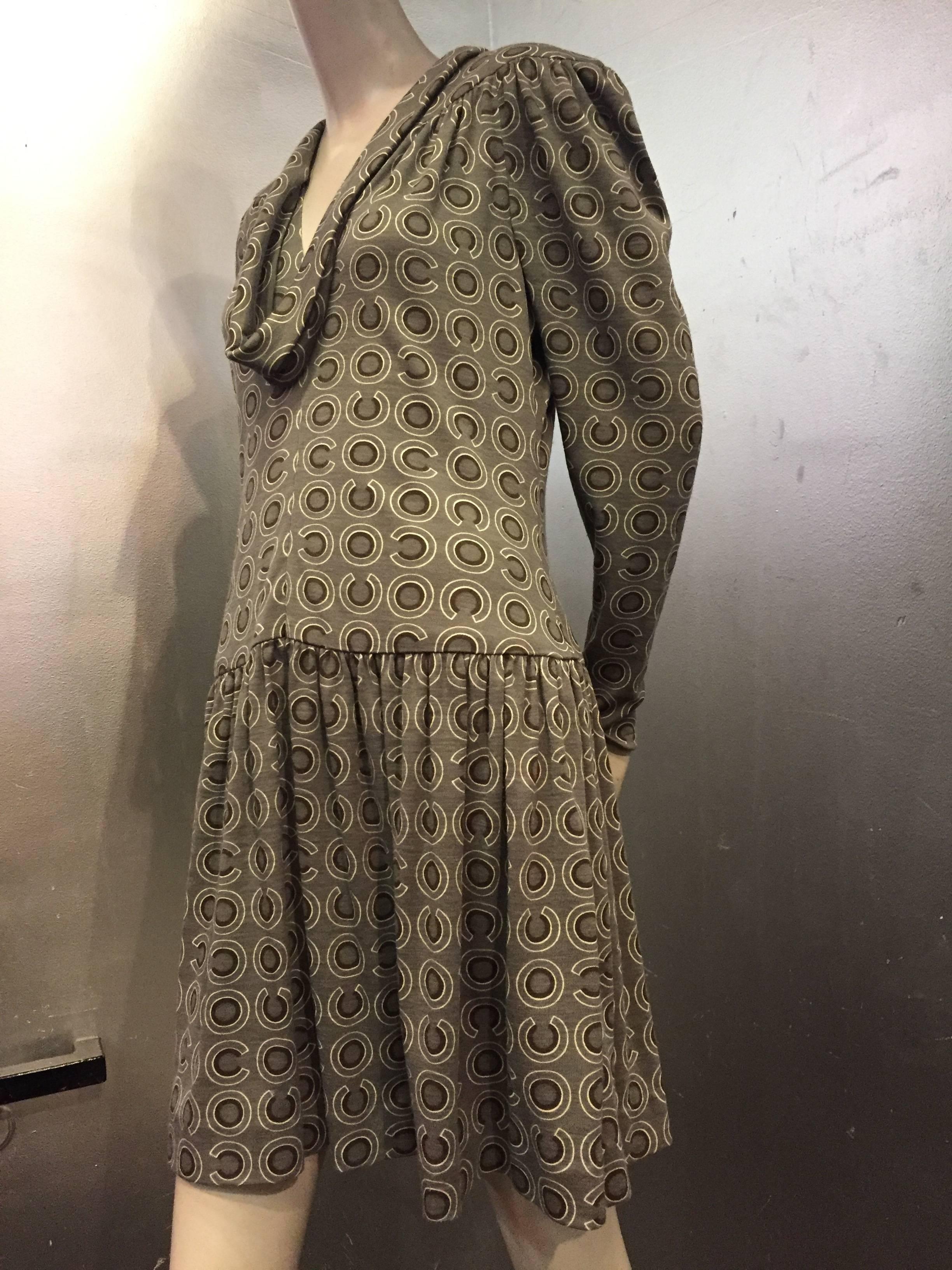 A lovely 1990s Chanel gray wool jersey drop-waist dress in a 1920s-inspired style with gathered drop-waist skirt, deeply draped and banded neckline, gathered shoulders and yoke at back.  Unlined. 

Marked a French 44. 