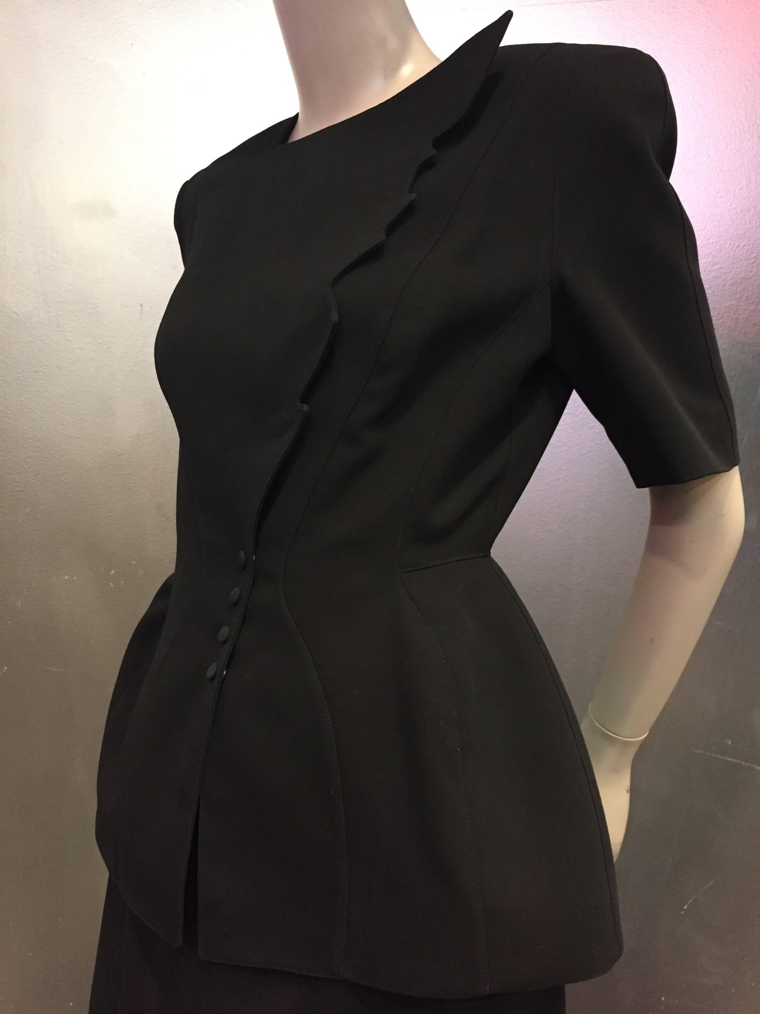 A fabulous iconic 1980s Thierry Mugler black gabardine suit, from his "Wasp Woman" series:  precision darting and sculptine with signature snaps and white "Lightning" hemline. 