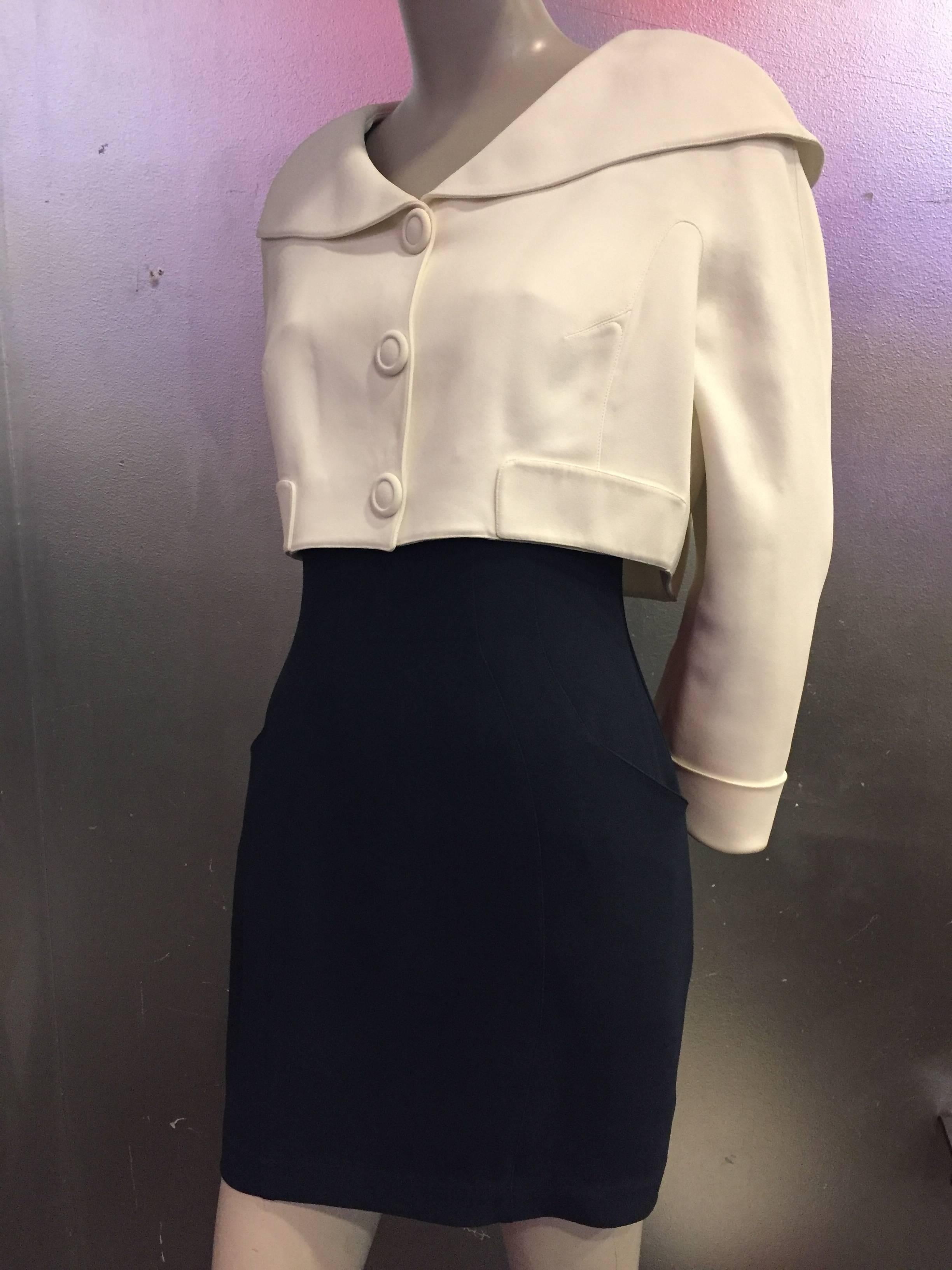 A wonderful resort "sailor-styled" 1980s Thierry Mugler 2-piece dress and jacket ensemble:  Dress is in navy crepe, cut above the knee with wide straps and a cream band around the bust.  Cream jacket is cropped with a large rounded sailor