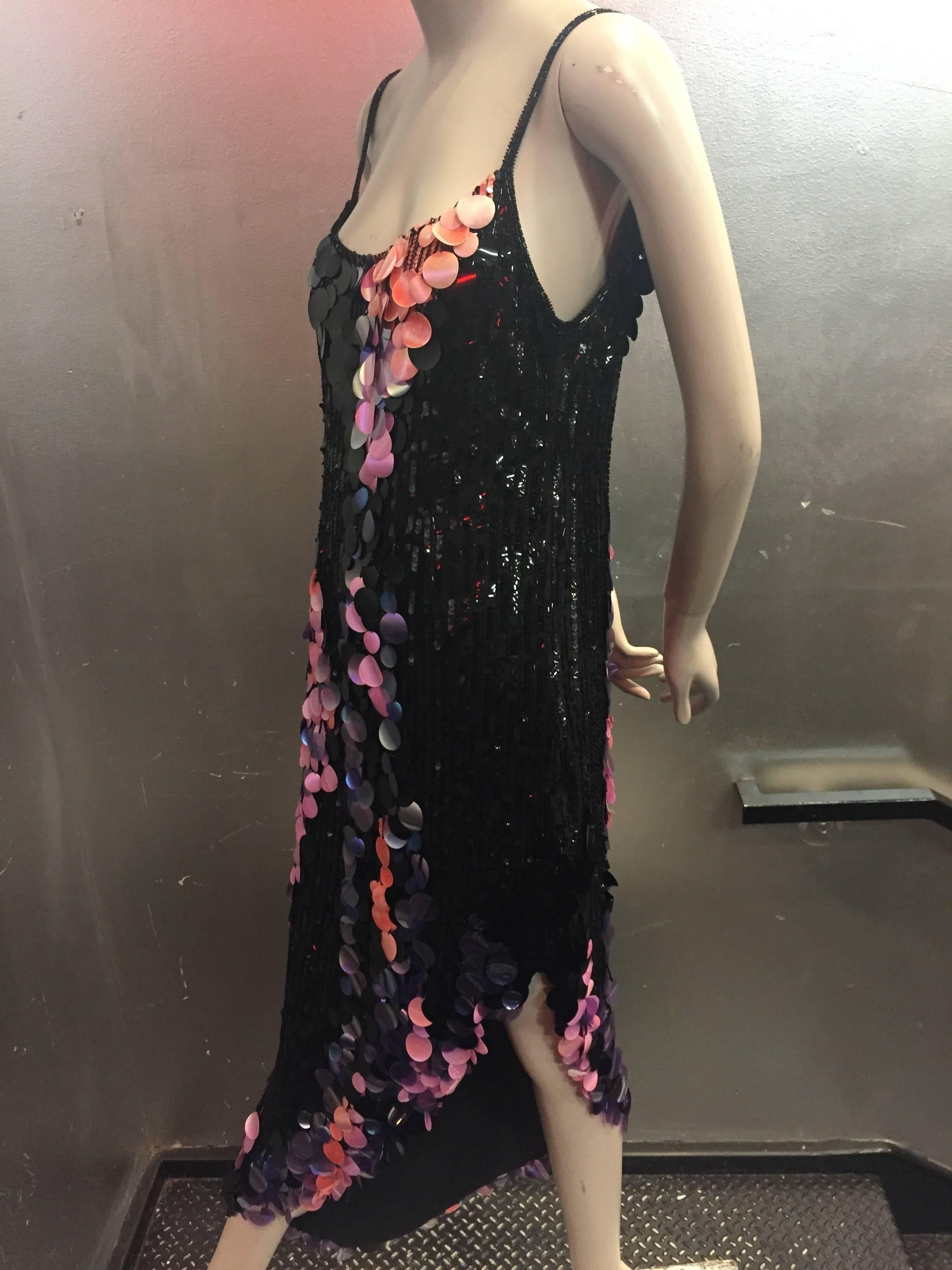 A fabulous 1970s Bob Mackie asymmetrical hem dancing dress in black sequins on silk with pink and purple iridescent paillette fringe. Lined 