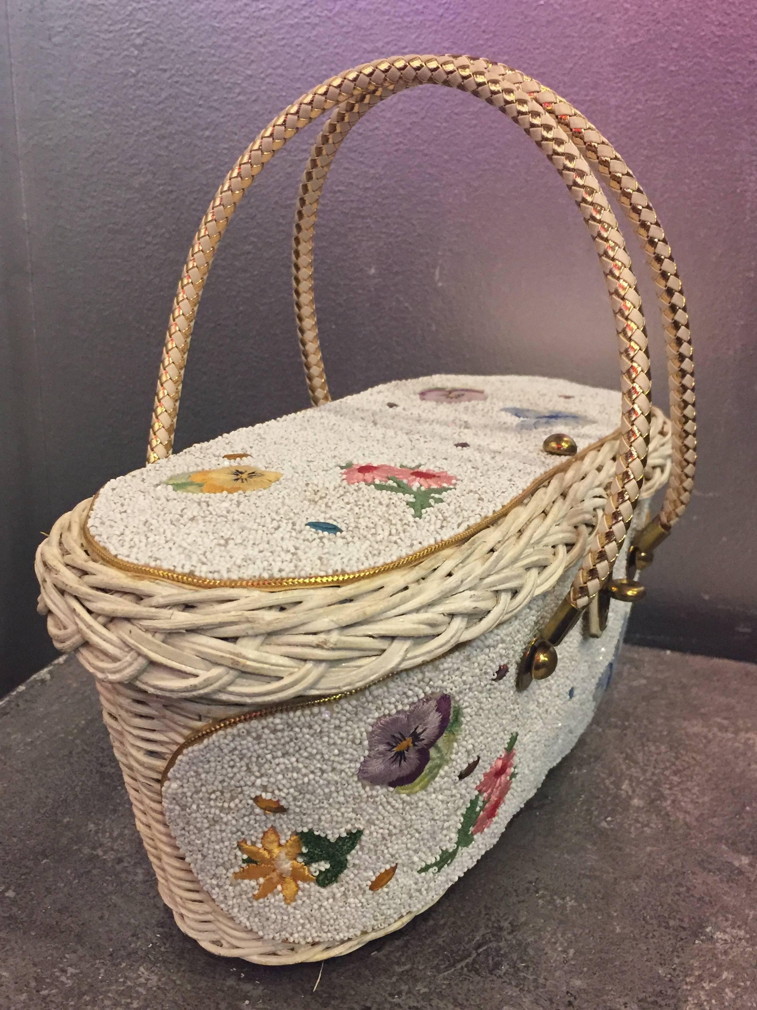 A fantastic white encrusted and beaded wicker basket style handbag. Double woven handles accent a floral and butterfly beaded motif in soft pastels. The bag is fully lined in pink satin. 