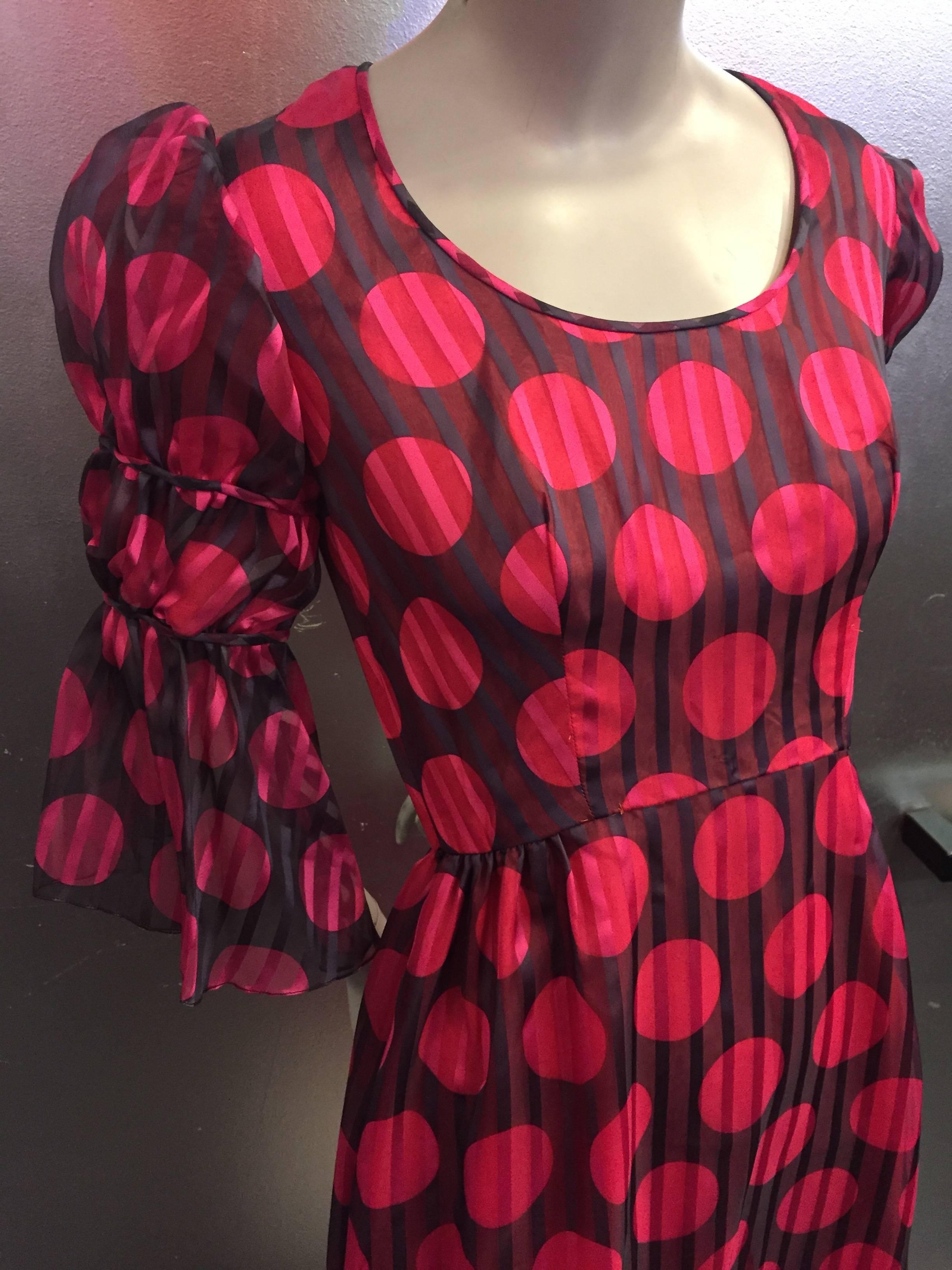 A vibrant and original late 1960's Sarmi in a pattern of oversize shocking pink polka dots set against a chocolate background, both with semi-sheer stripe throughout. Romantic Juliette elbow length sleeves give this dress a high fashion feel. This