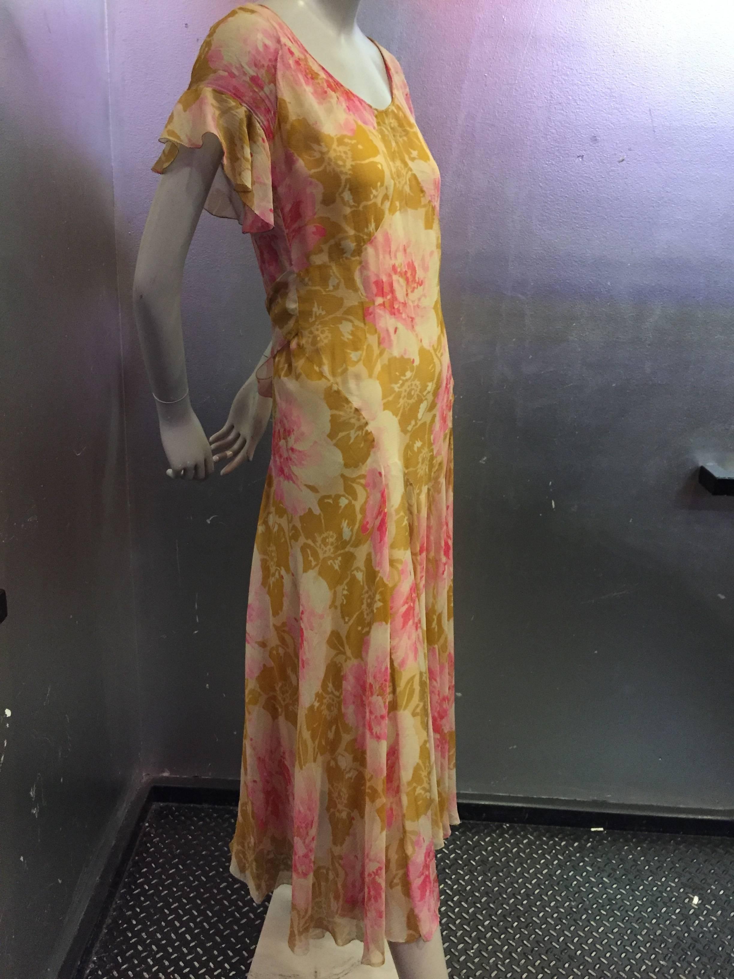 The colors of this gossamer silk printed chiffon tea dress are stunningly ethereal and of a bygone era.  The watercolor pattern is reminiscent of a french wallpaper. Flounced sleeves and bias inserts throughout create romantic drama. A beautiful