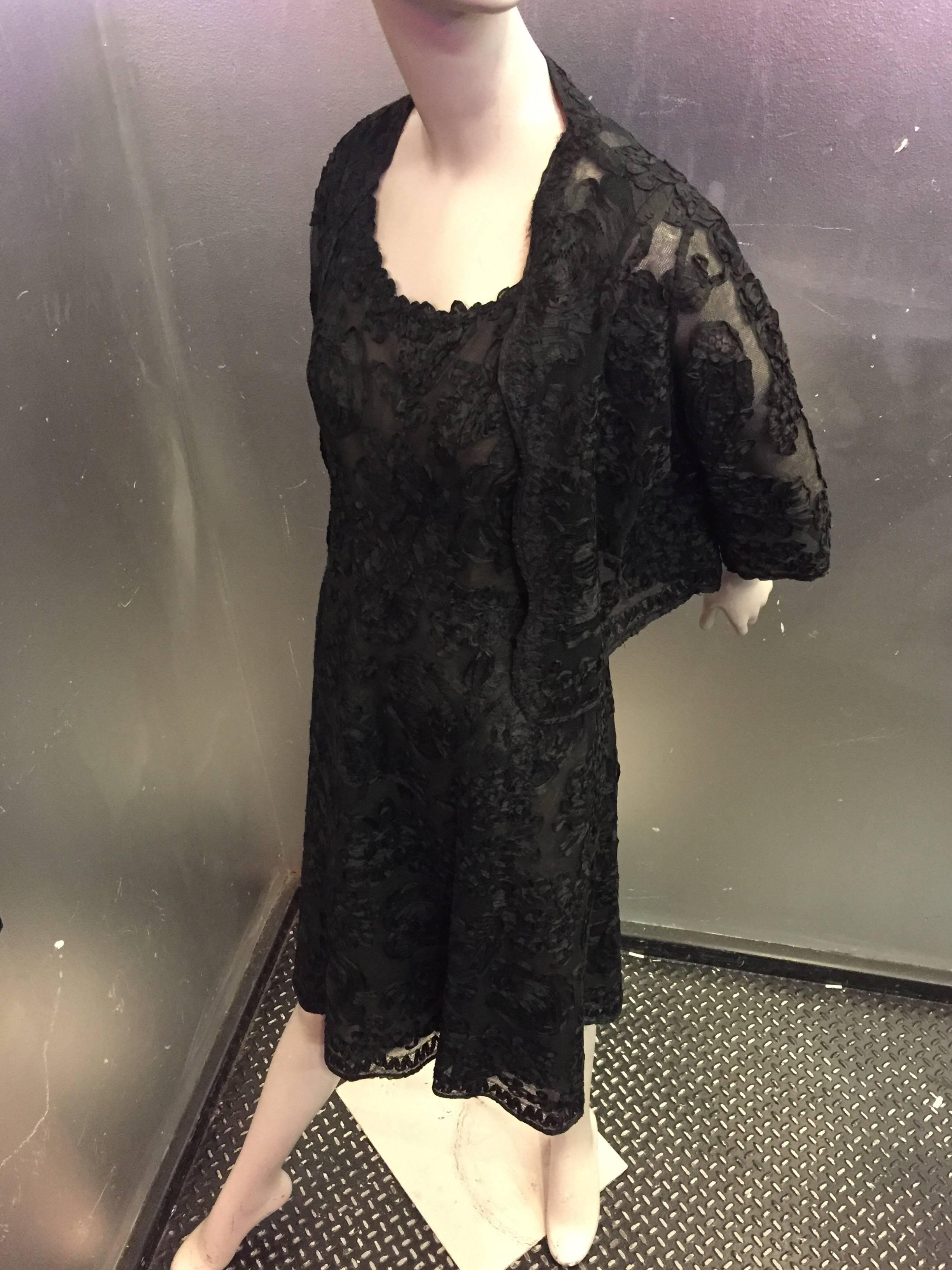 A sensationally classic Christian Dior numbered Couture ensemble in black net with sculpted ribbon lace and layered silk chiffon base. 

This luxurious and delicate ensemble consists of a dress and jacket, both of a quintessential Dior silhouette.