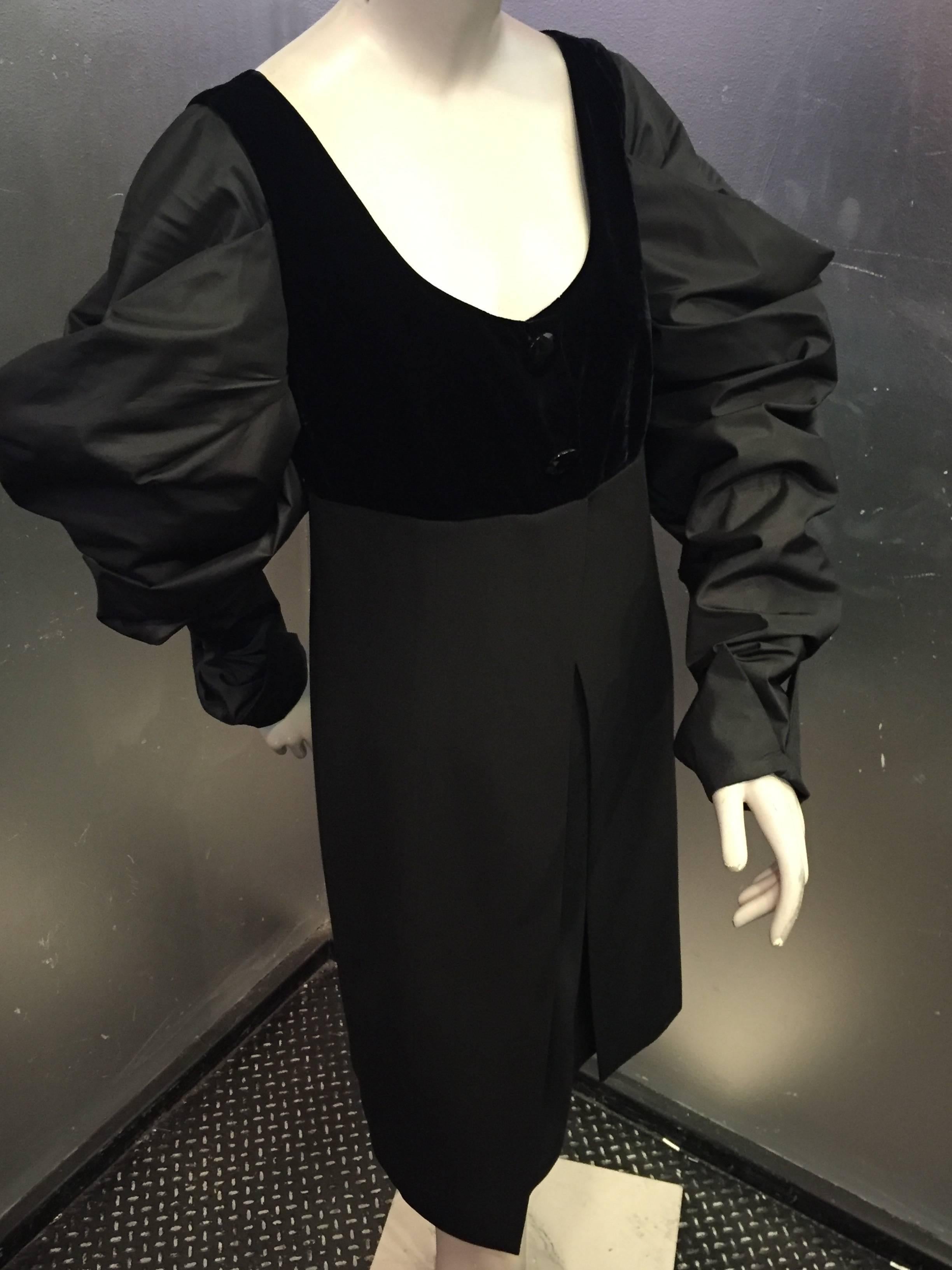 A sexy avant guarde 1980s Gianfranco Ferre knee-length black wool cocktail dress with sheer deep back and extreme leg-o-mutton silk sleeves.
