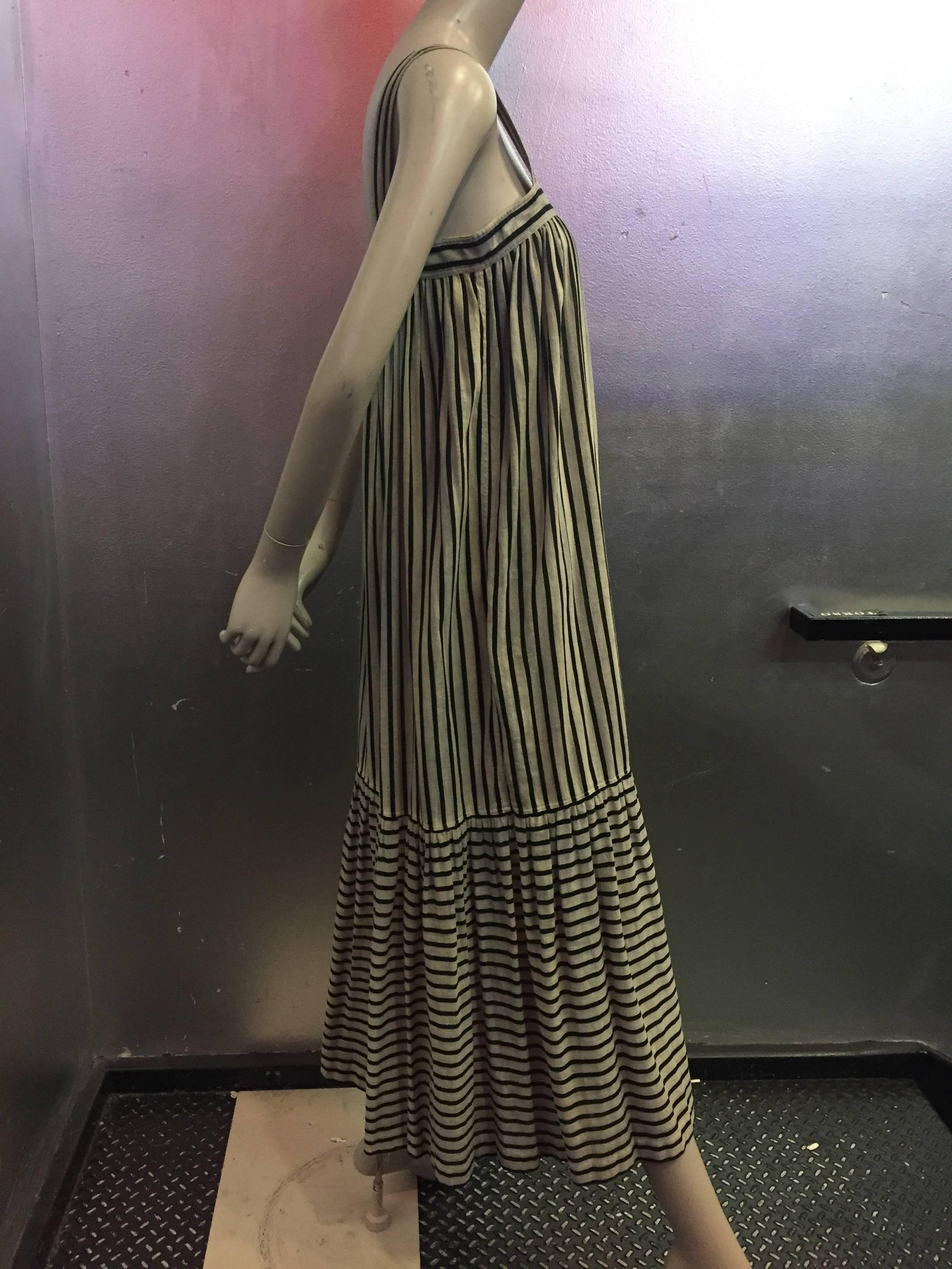 A fantastic woven cotton Saint Laurent dress for warmer weather. Made of parchment colored and black stripes, this is a great dress for belts and espadrilles. 


Measures 32 inches across the top of the bust, with the rest of the dress open. Length