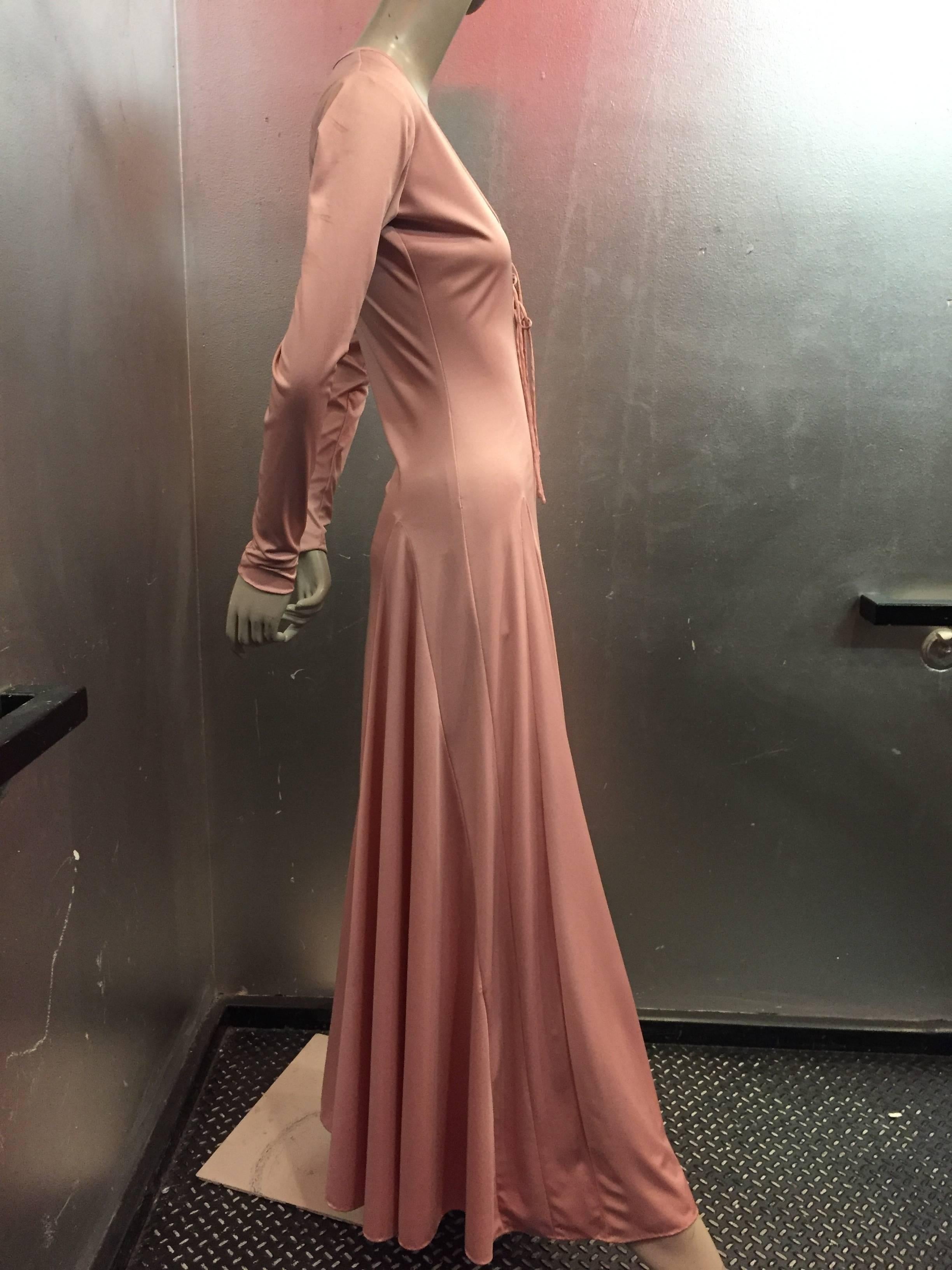 A sexy 1970s Esteban rose pink silk jersey disco gown or maxi dress with lace up detail at neckline, long sleeves and flared hemline. Great for Dancing!! Marked a size 8. Fits a modern 4-6.