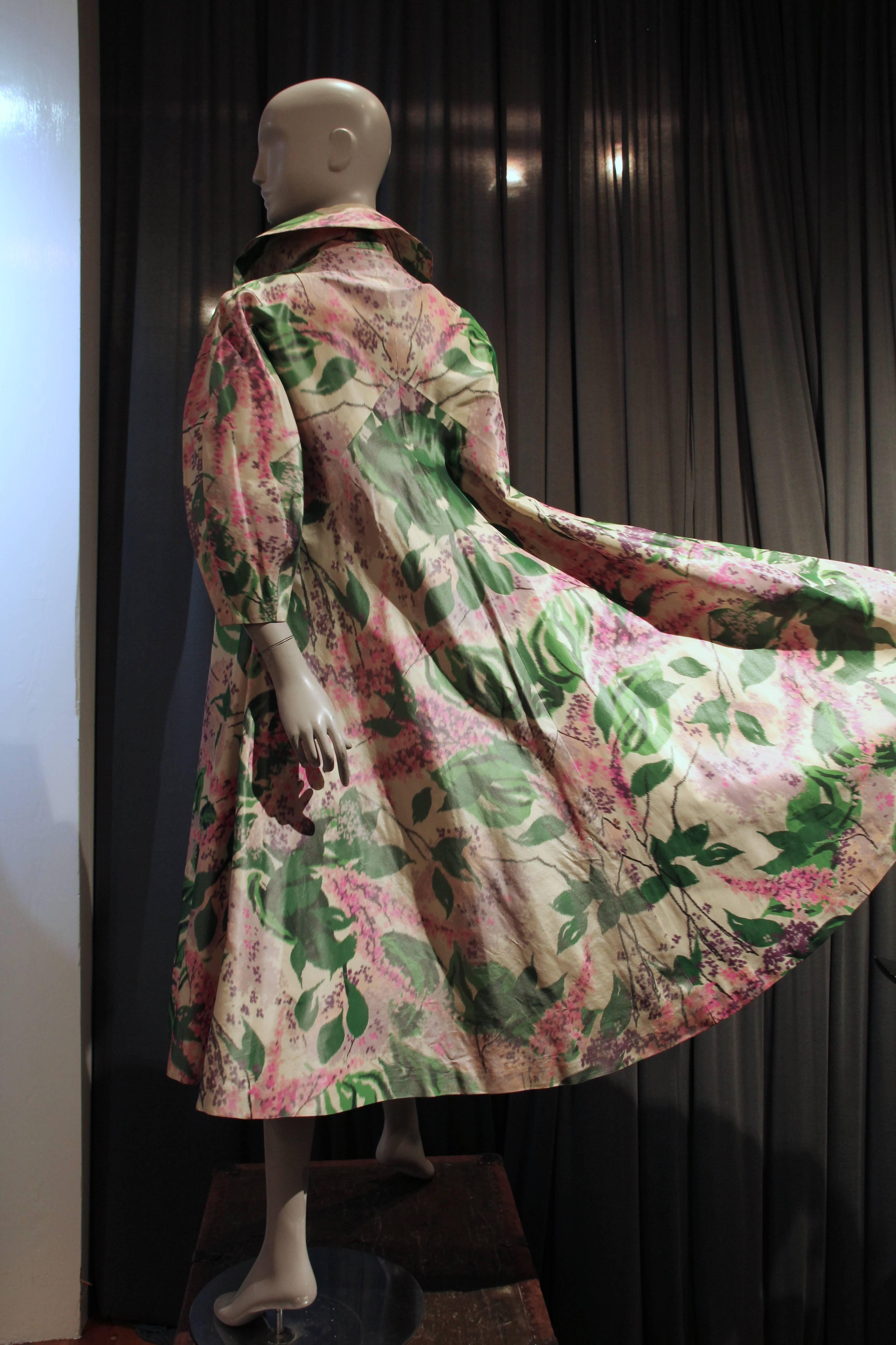 An absolutely divine 1950s Irene silk opera coat in a full swing style. Mid-calf or nearly ankle length with a full rounded sleeve silhouette, shawl collar and 3/4 length sleeves.  It screams out for opera gloves to match the heavenly abstract lilac