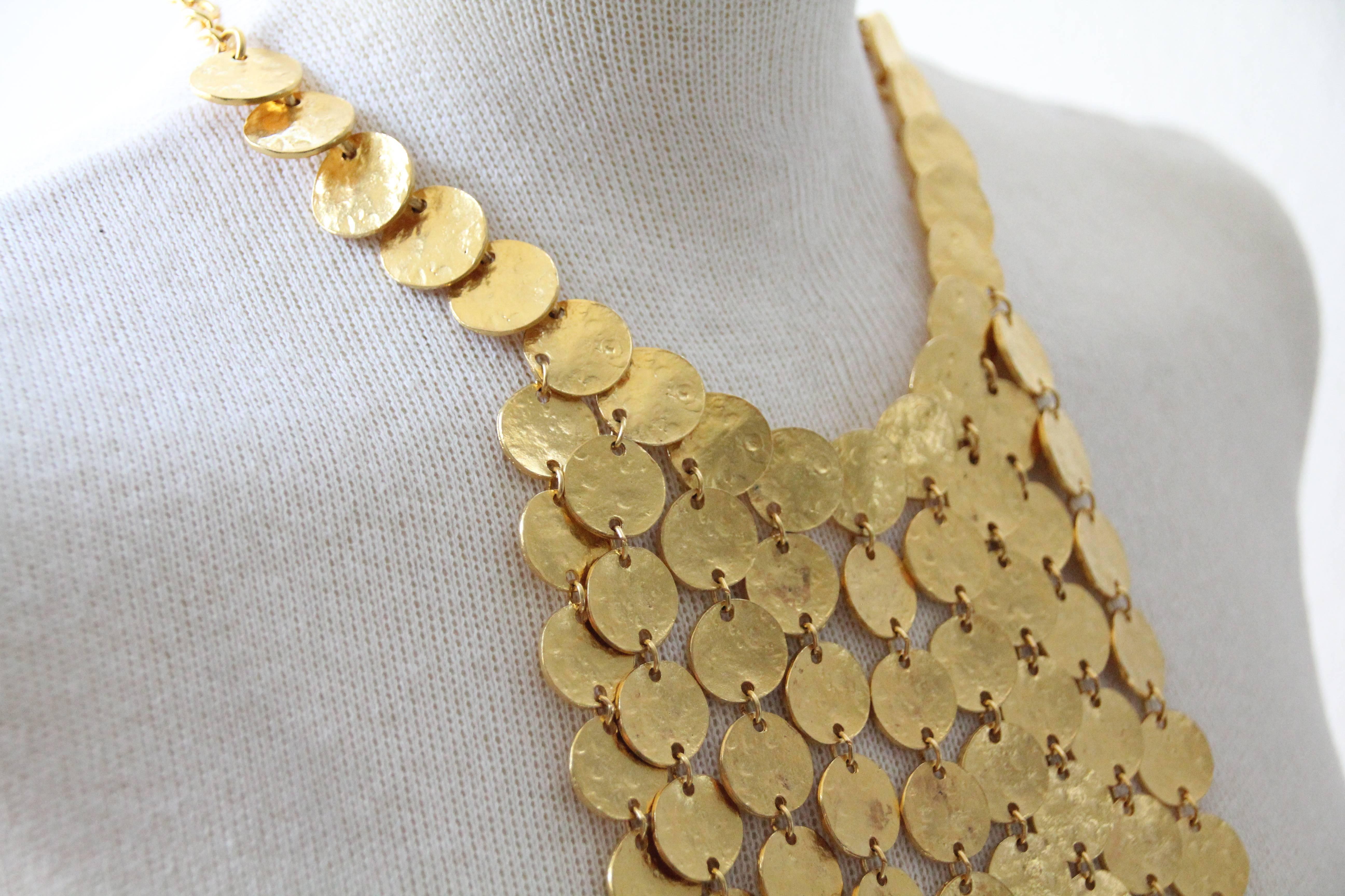 A glamorous 1970s Kenneth Jay Lane hammered coin waterfall bib necklace in graduated lengths from 5