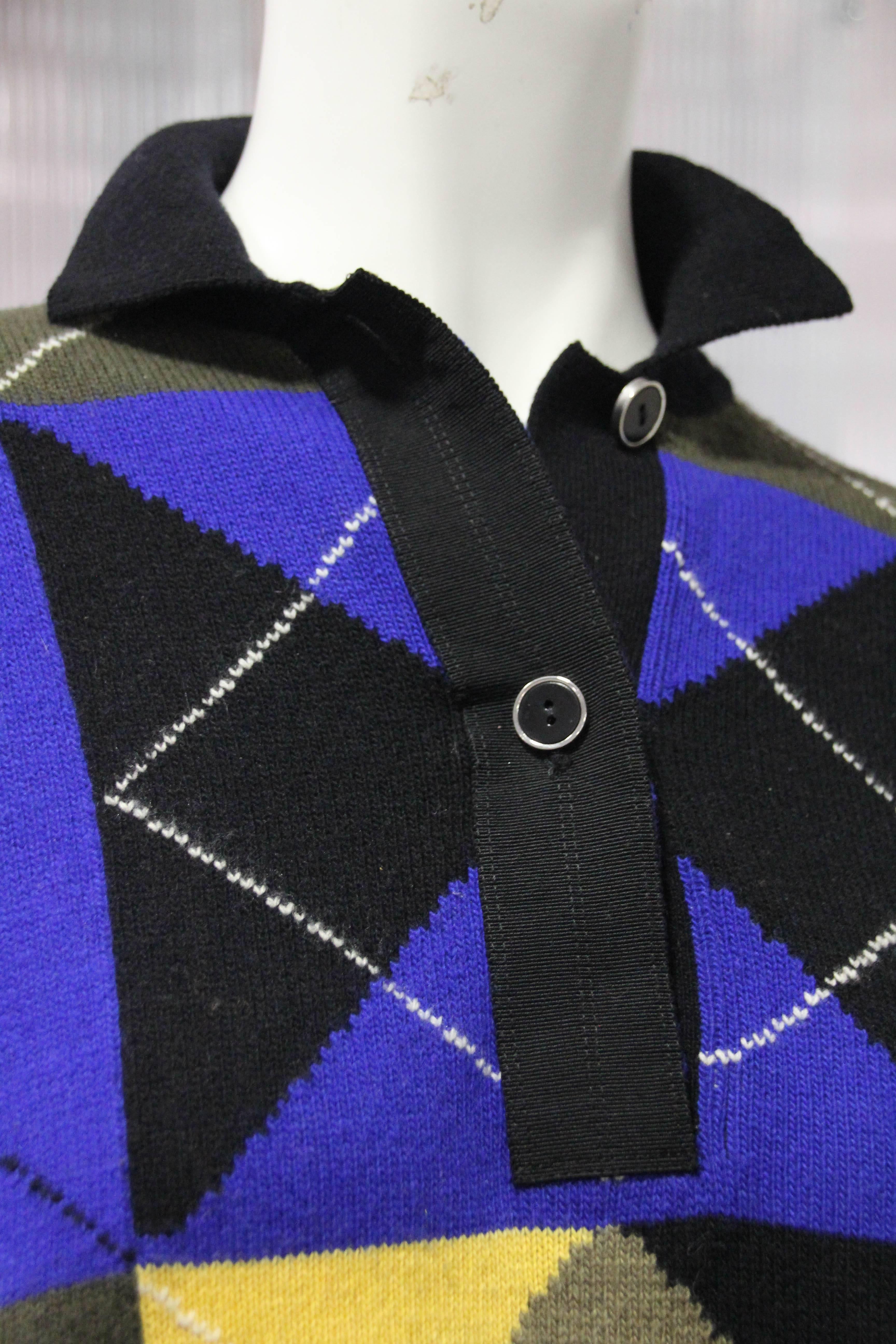 1980s Gianni Versace cropped wool argyle polo sweater in blue, yellow, white and black. Front button placket collar. Drop-shoulder. Oversized fit.