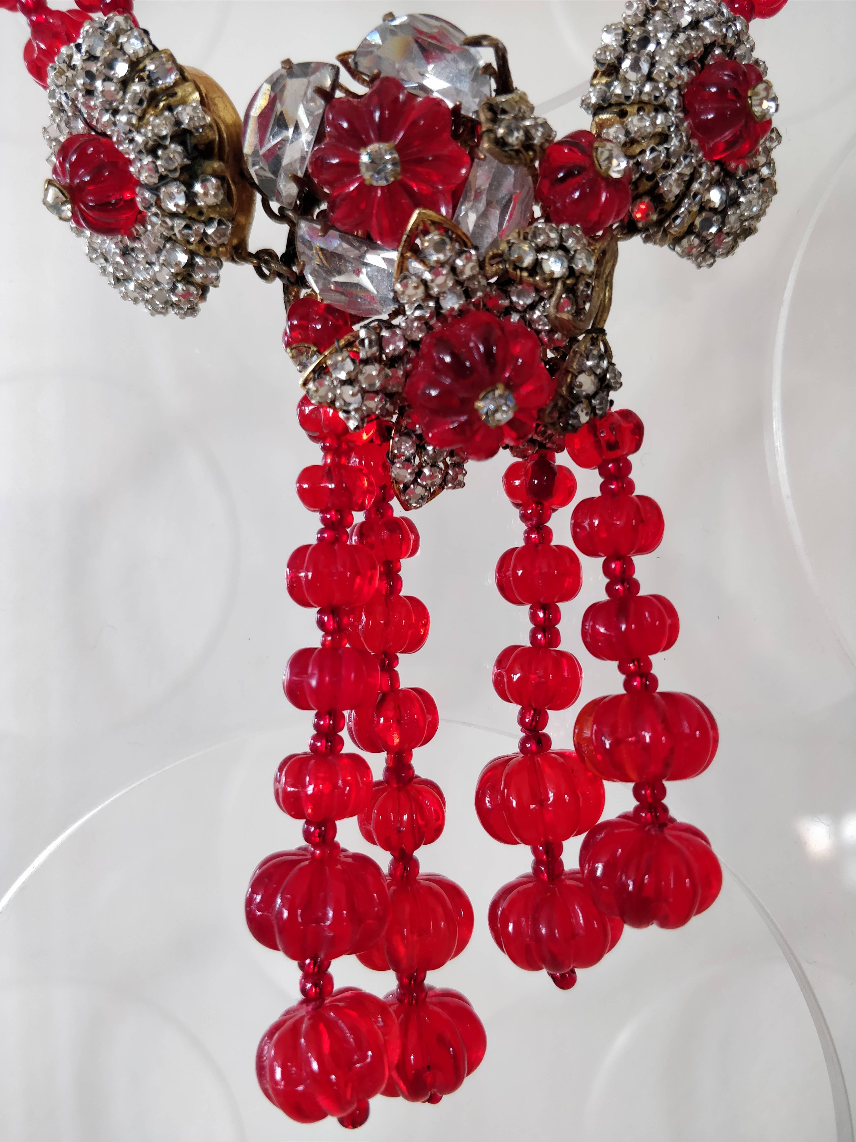 A stunning 1940s Miriam Haskell necklace and earring set: Haskell at her most extravagant, inspired by Cartier-style pieces of the period, uses ruby-red poured glass beads of graduated size and her signature wired rhinestone anchor pieces to create