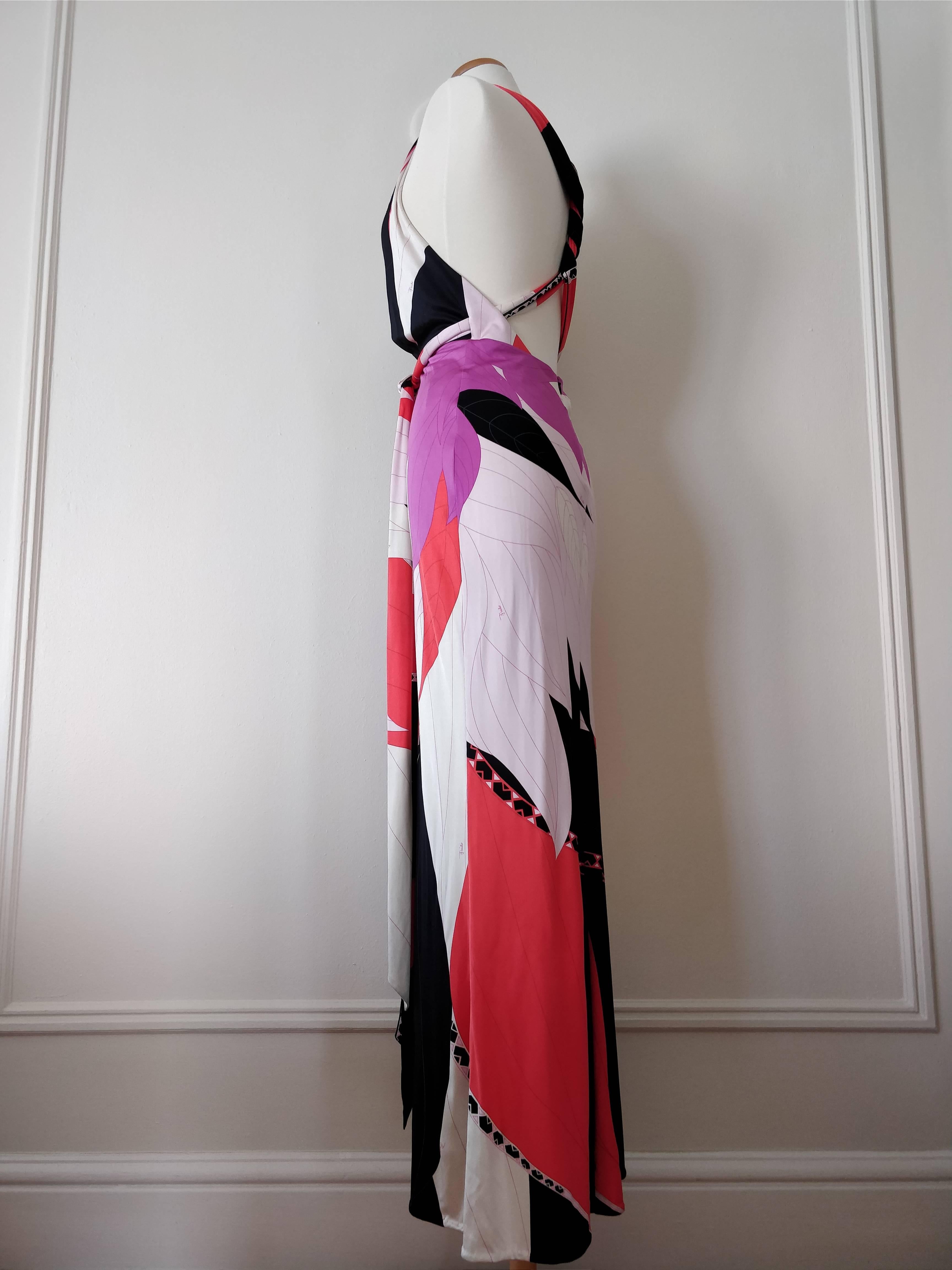 An Emilio Pucci silk jersey maxi dress in black, white, fuchsia and red with a halter neckline, twisted straps across a low-cut back and long tie.  Zipper at back. 