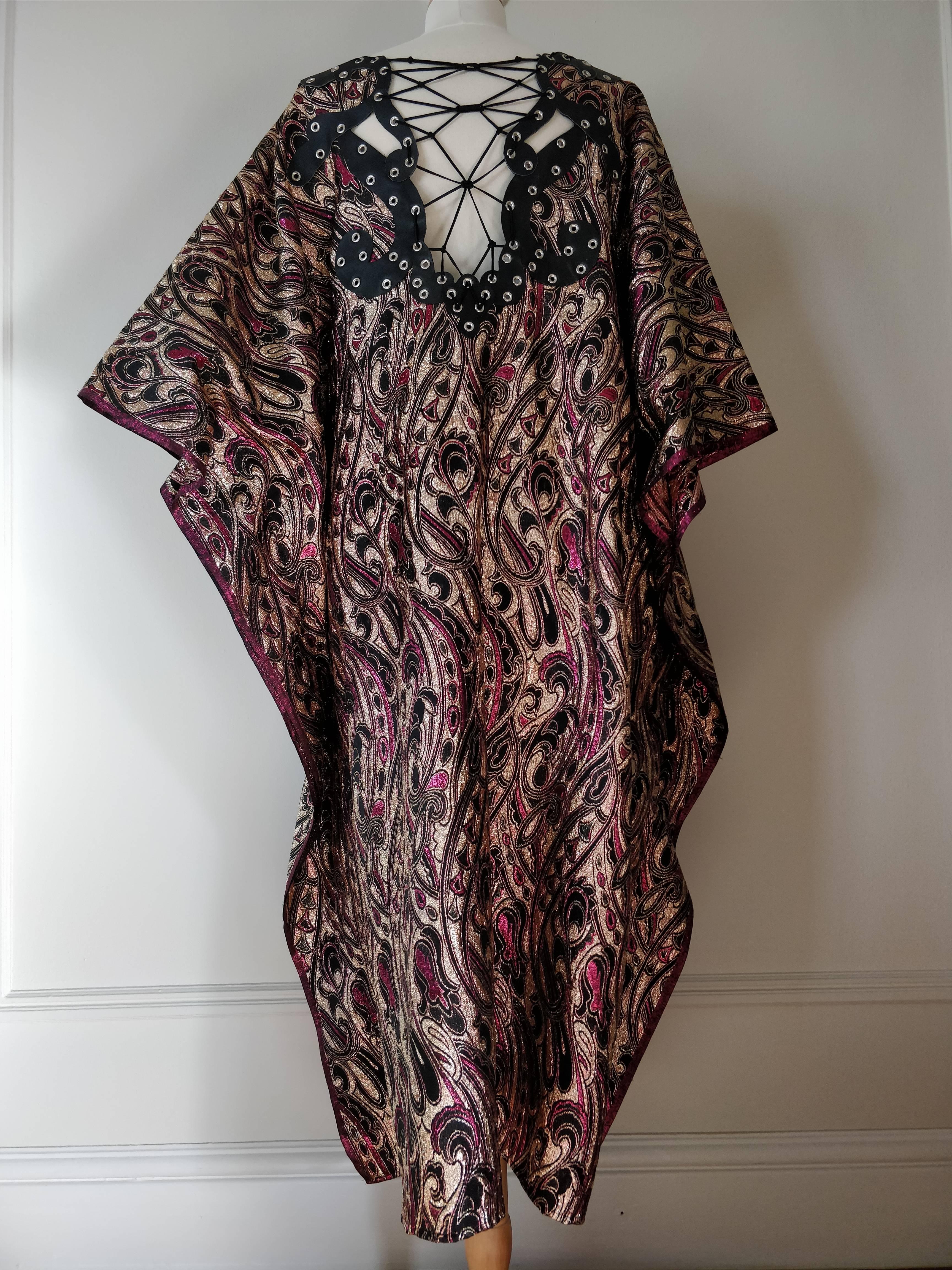 A custom-made vintage Indian paisley print lame caftan in burgundy and gold with hand-made leather applique, eyelets and lacing at neckline.  One size.