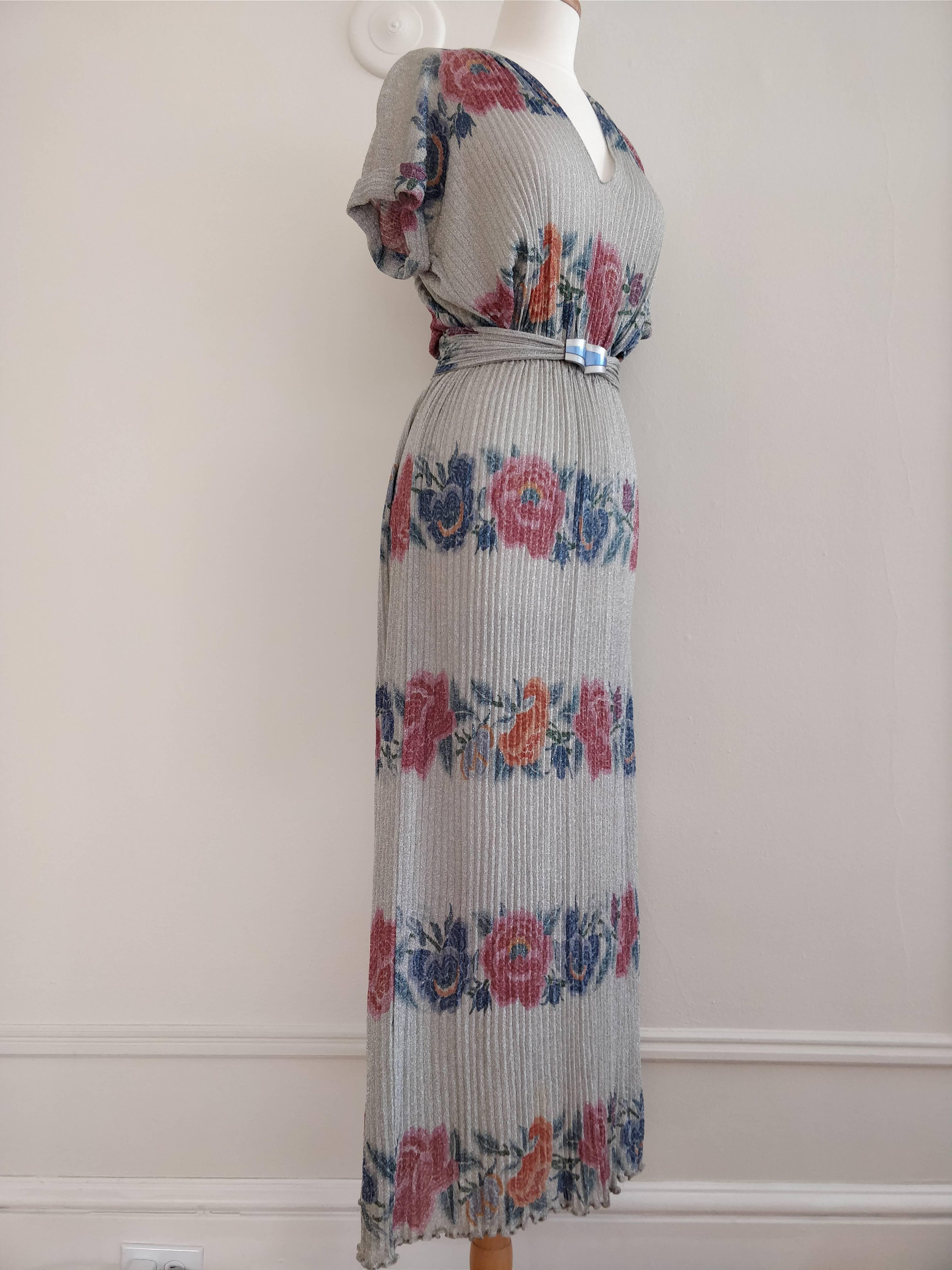 A beautiful 1970s Missoni maxi dress in a fine silver lame rib-knit:  V-neckline with wonderful floral bands reminiscent of a 1930s design surround the length of the dress.  Waist is elastic with a matching belt.  