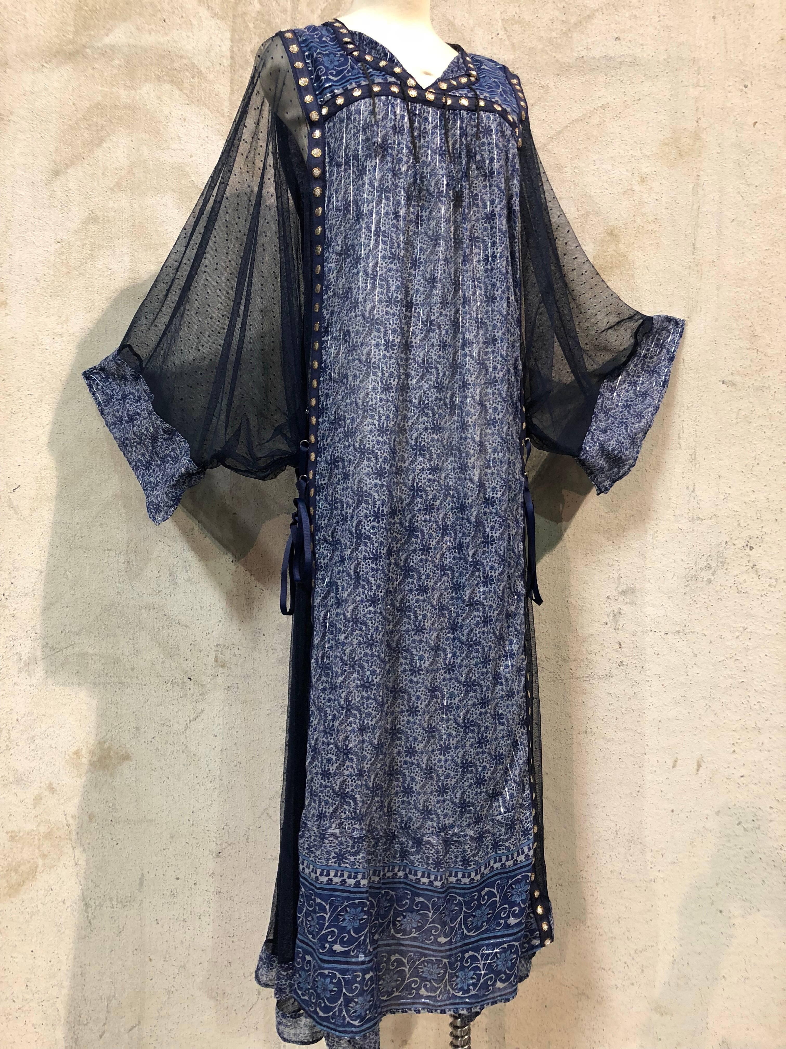 Featured here is a wonderful combination of textiles, mixing a soft sheer cotton print fabric from India and navy dotted net with metallic trim. This boho-style Kaftan features a dual option fit, either laced-up on the sides with ribbon ties for a