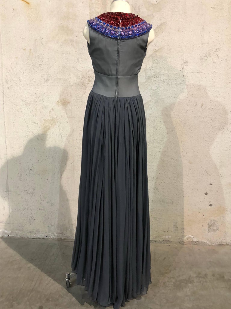 1968 Haute Couture Spring/Summer Christian Dior by Marc Bohan.  A stunning slate grey textured silk sleeveless column gown lined in muslin with fitted high waist band and full chiffon layered skirt with train.  Extravagant and vibrant-colored wide