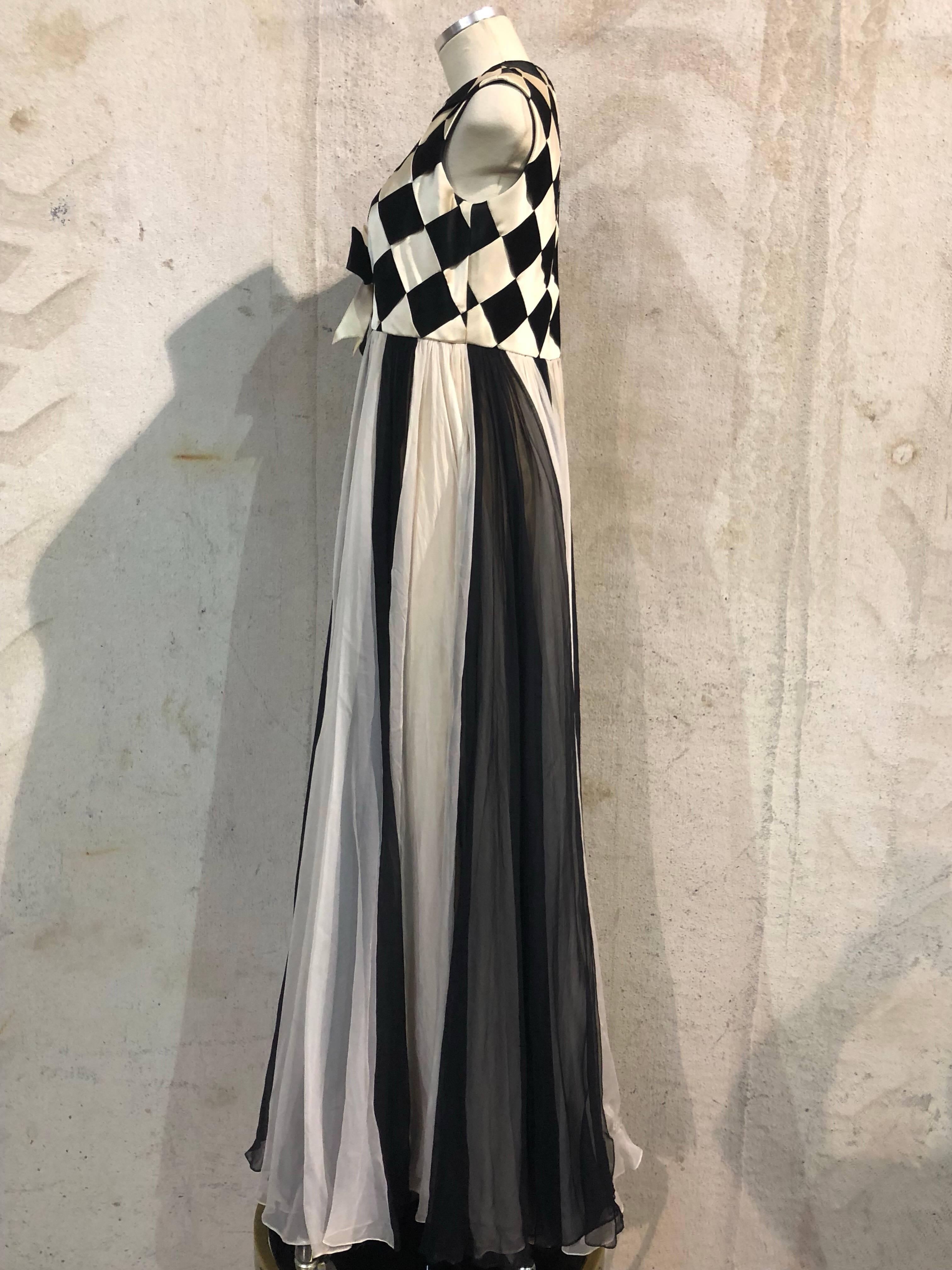 1960s Sarmi black & white Harlequin evening gown: black and white silk satin ribbon woven sleeveless bodice with bow at front under bust.  At empire, ribbons flow into bias cut godet panels which are full and layered. Fully lined in rayon crepe. 