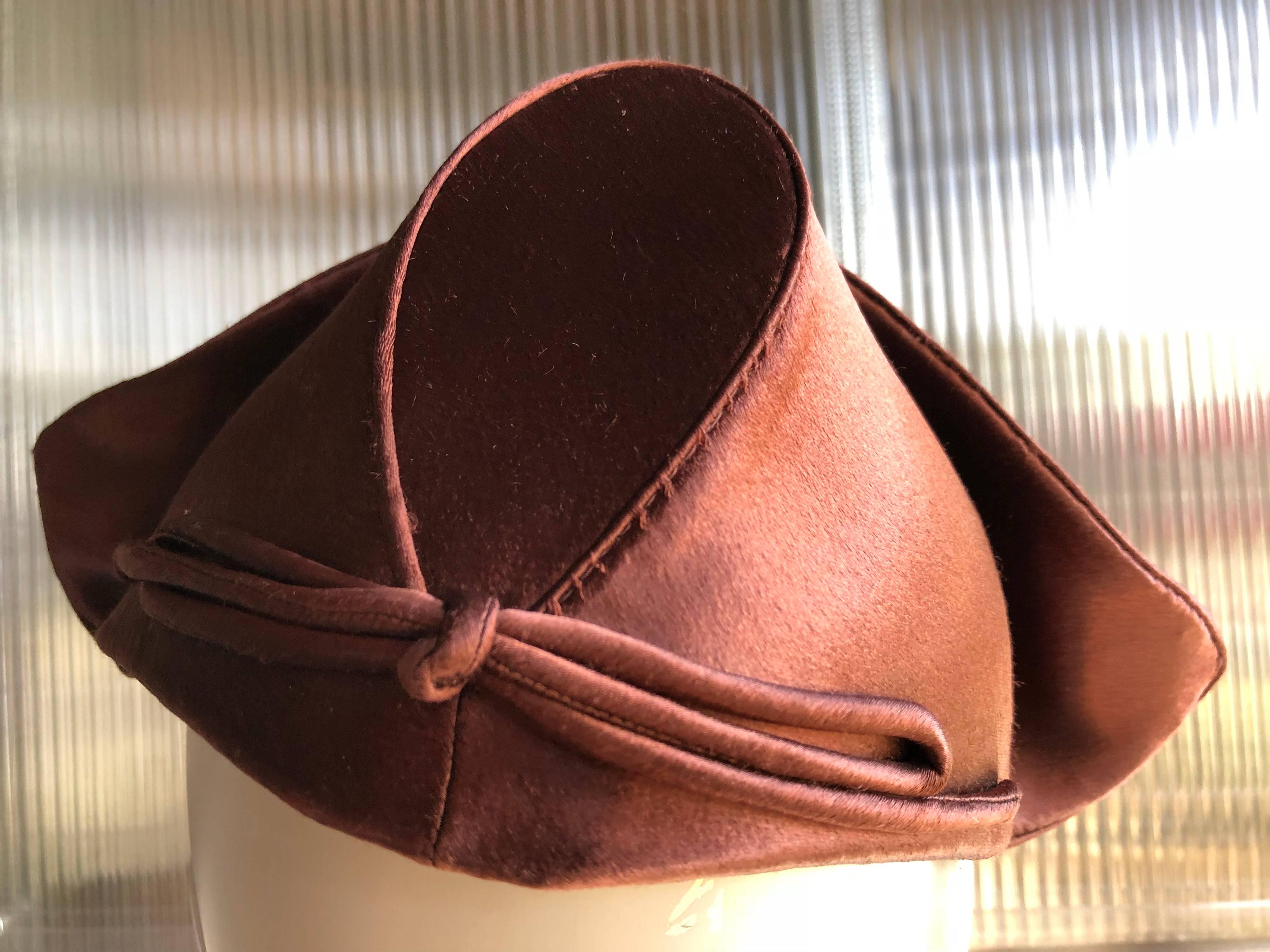 An adorable 1940s Coret of San Francisco chocolate brown silk satin Dutch-style cocktail hat with upswept sides and structured bonnet-like crown.  Hand-sewn. Comb attach at inside front to aid in securing hat. 