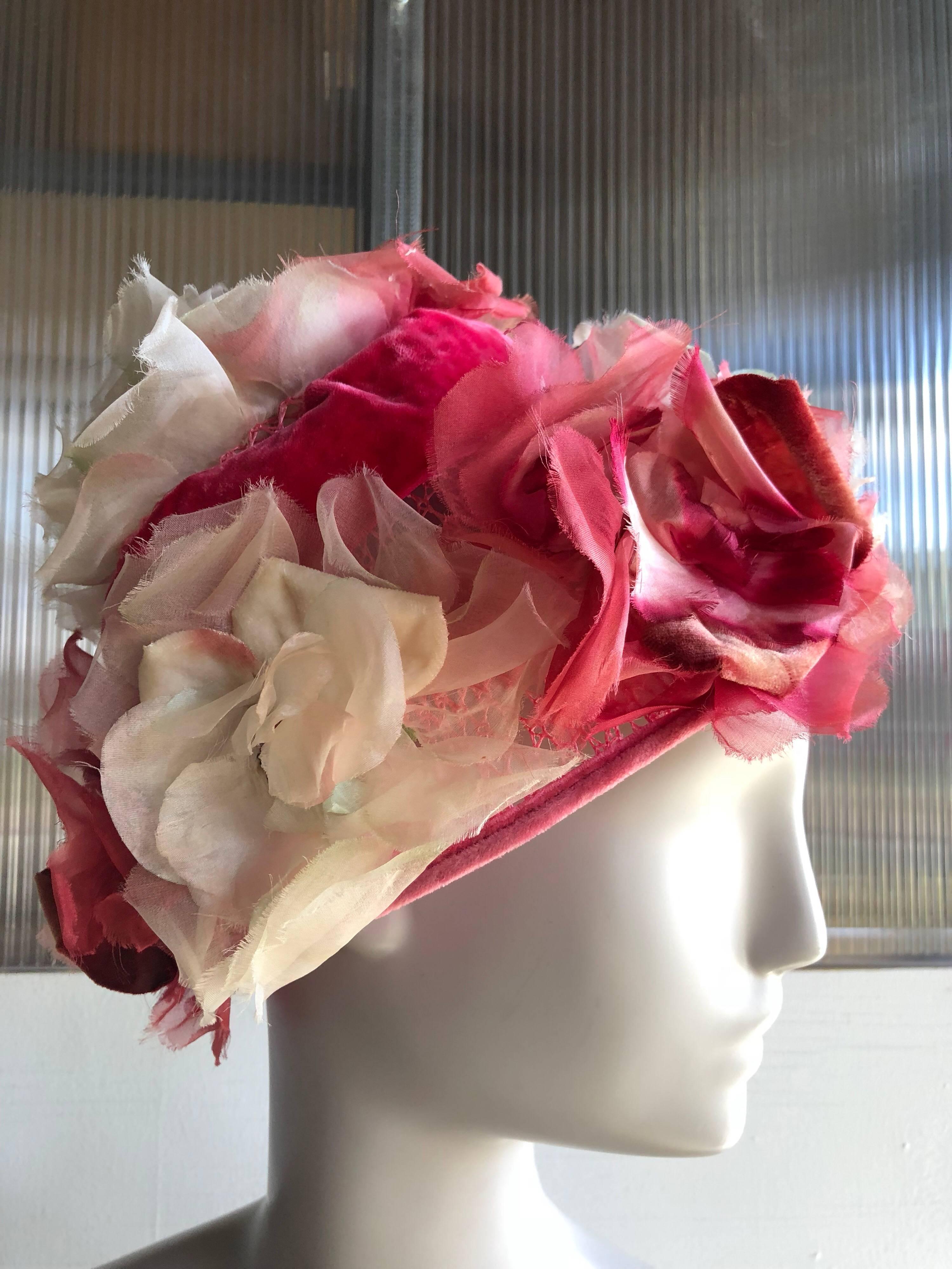 A gorgeous 1950s Mr Josephs spring flower pot-shaped hat with pink, white and fuchsia silk florals mounted on a stiffened net base and embellished with a pink velvet ribbon band.  Medium size. 