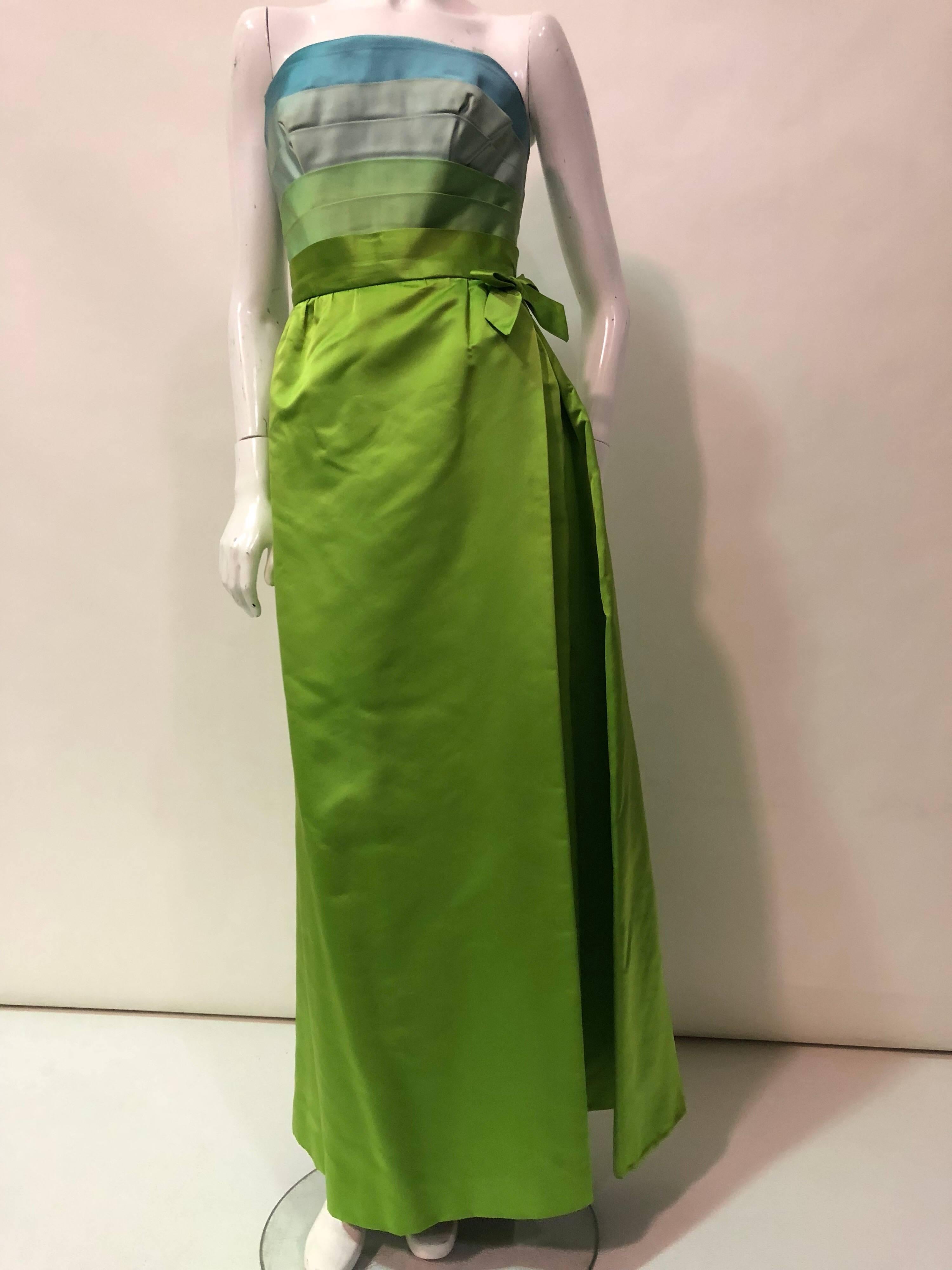 1950s Philip Hulitar silk satin column silhouette gown with aqua, turquoise and chartreuse pleated, strapless bodice.  Bodice is boned and structured.  Zipper at back.  Skirt has the appearance of a wrap-style with pleating and a bow at left side.  