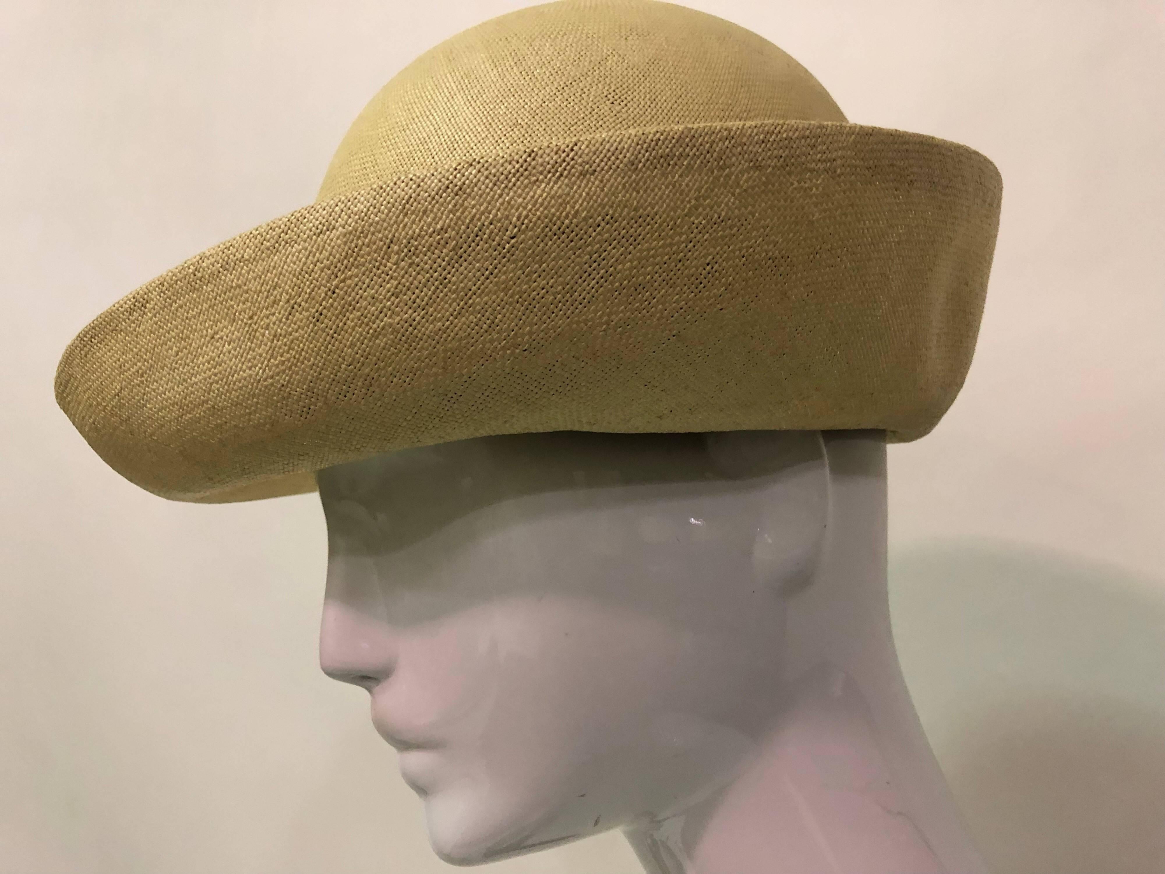 1960s James Galanos Panama-weave boater-style tailored natural straw summer hat with black grosgrain band and navy blue silk lined crown.  Uniquely styled brim. 